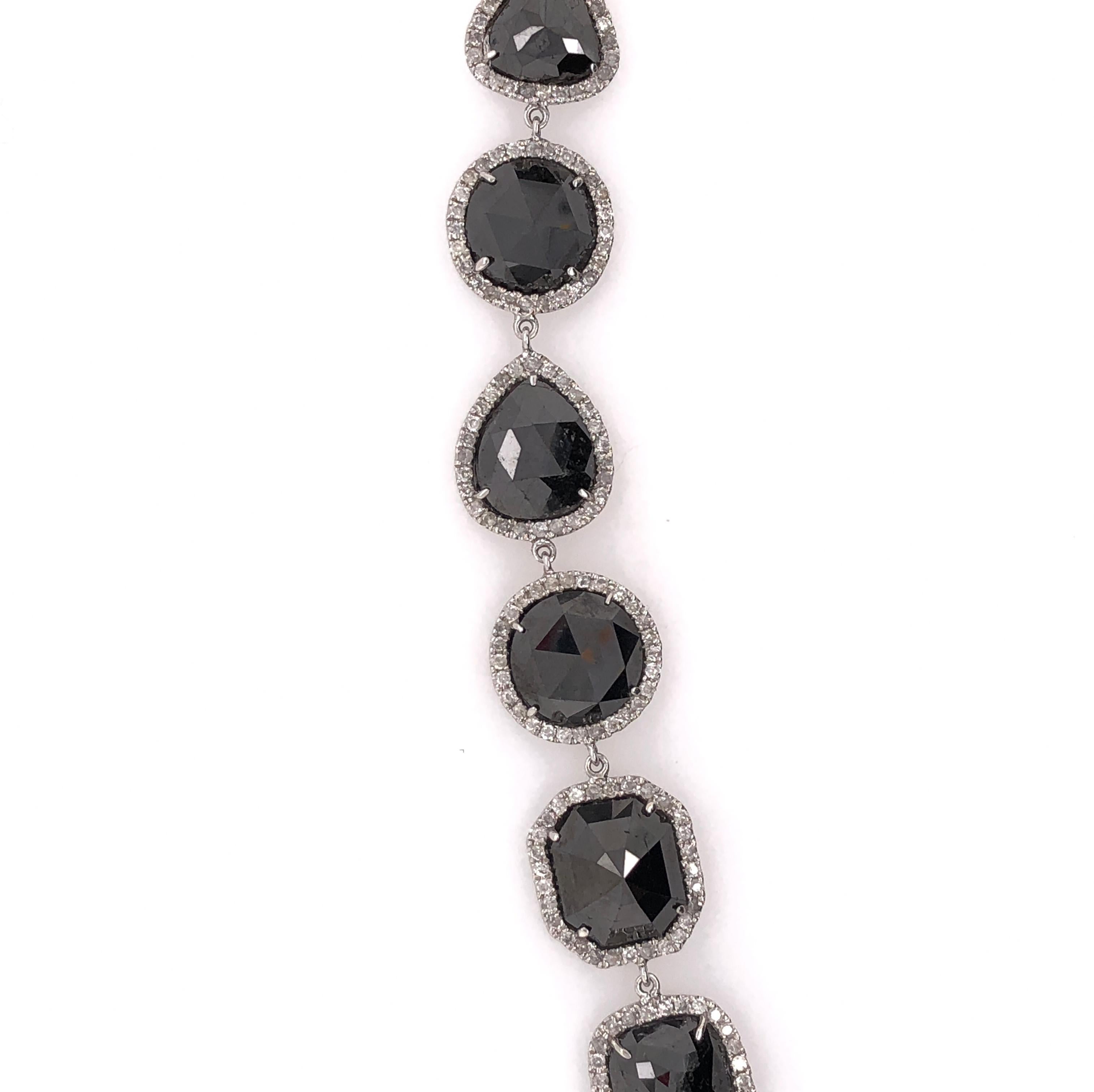 18K White Gold
Black Diamond: 35.76ct total weight.
Diamonds: 2.10ct total weight.
All diamonds are G-H/SI stones.
Length - is approximately 19.4cm/7.64inches.
Width - is approximately 1.1cm/0.44inches.