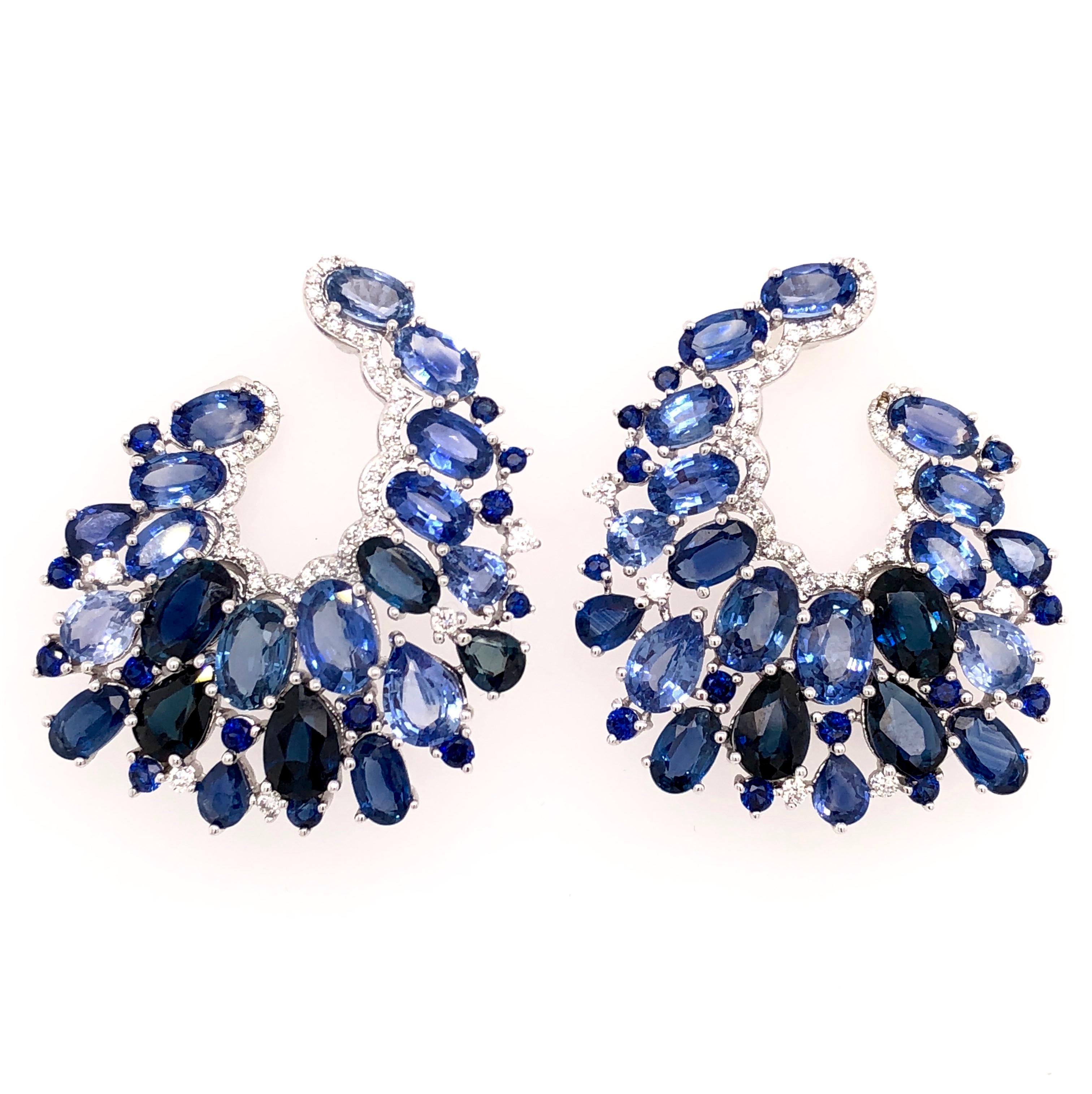 Midnight Blue Collection 

Oval blue Sapphire and Diamond C shaped earrings set in 18K white gold.

Sapphire: 14.49ct total weight.
Diamonds: 0.36ct total weight.
All diamonds are G-H/SI stones.
Height - is approximately 3cm/1.18inches.
Width - is