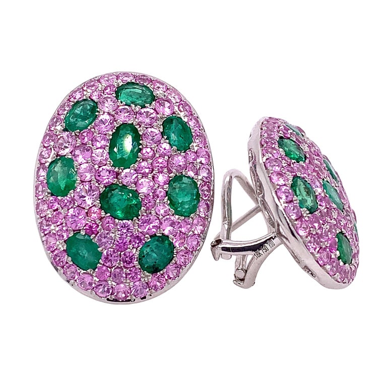 Cherry Blossom Collection

This stunning pair of earrings features an oval cut Emerald dotted on several size of  Pink Sapphire sitting on 18k white gold. It is set in oval shape design and is secured with a clip for easy wearing.

Pink Sapphire: