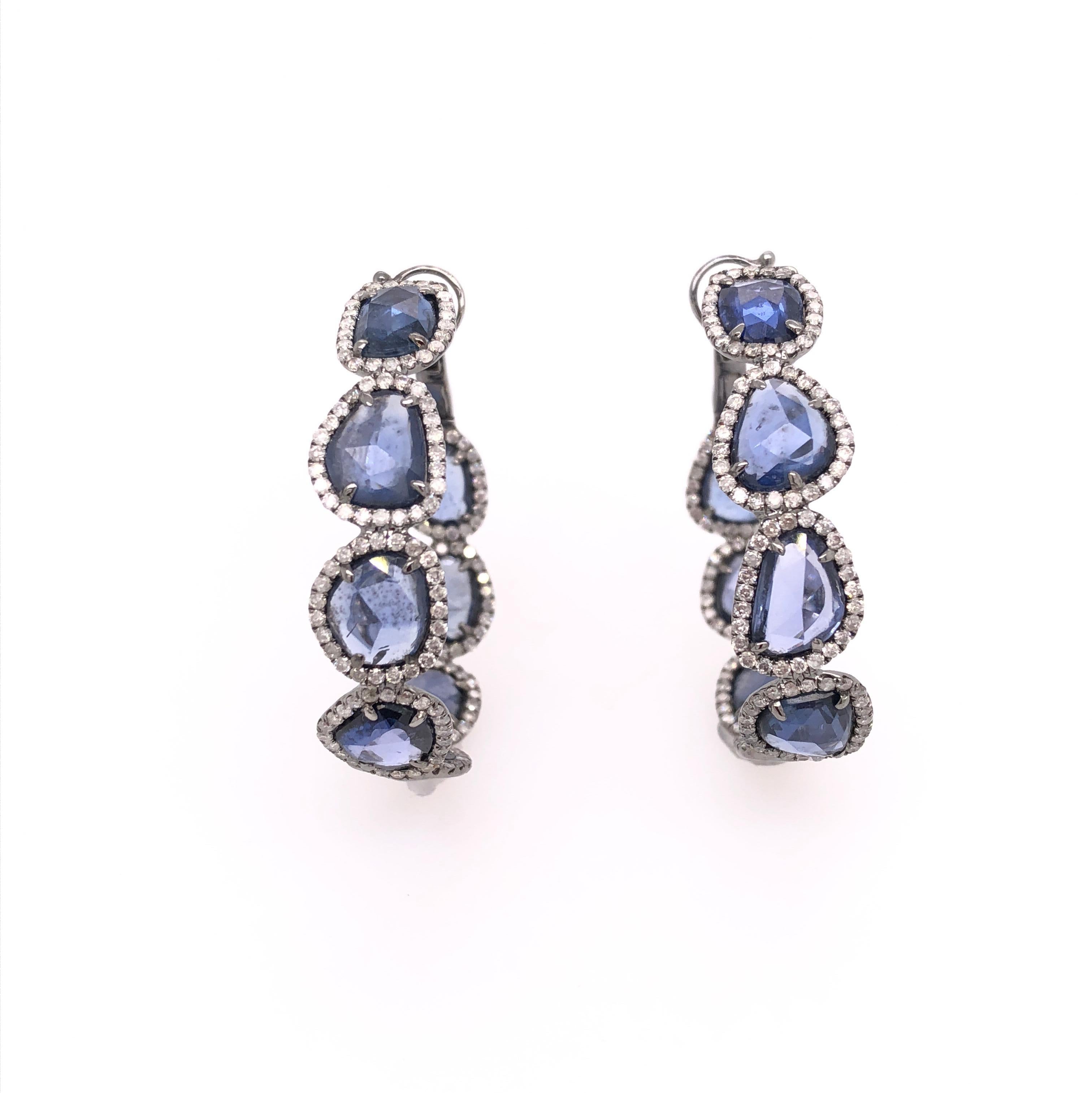 Midnight Blue Collection

Rose cut blue Sapphire hoop earrings set in 18K black rhodium gold with thin pavé diamonds around each stone. 

Blue Sapphires: 16.05ct total weight.
Diamonds: 1.78ct total weight.
All diamonds are G-H/SI stones.
Width - is