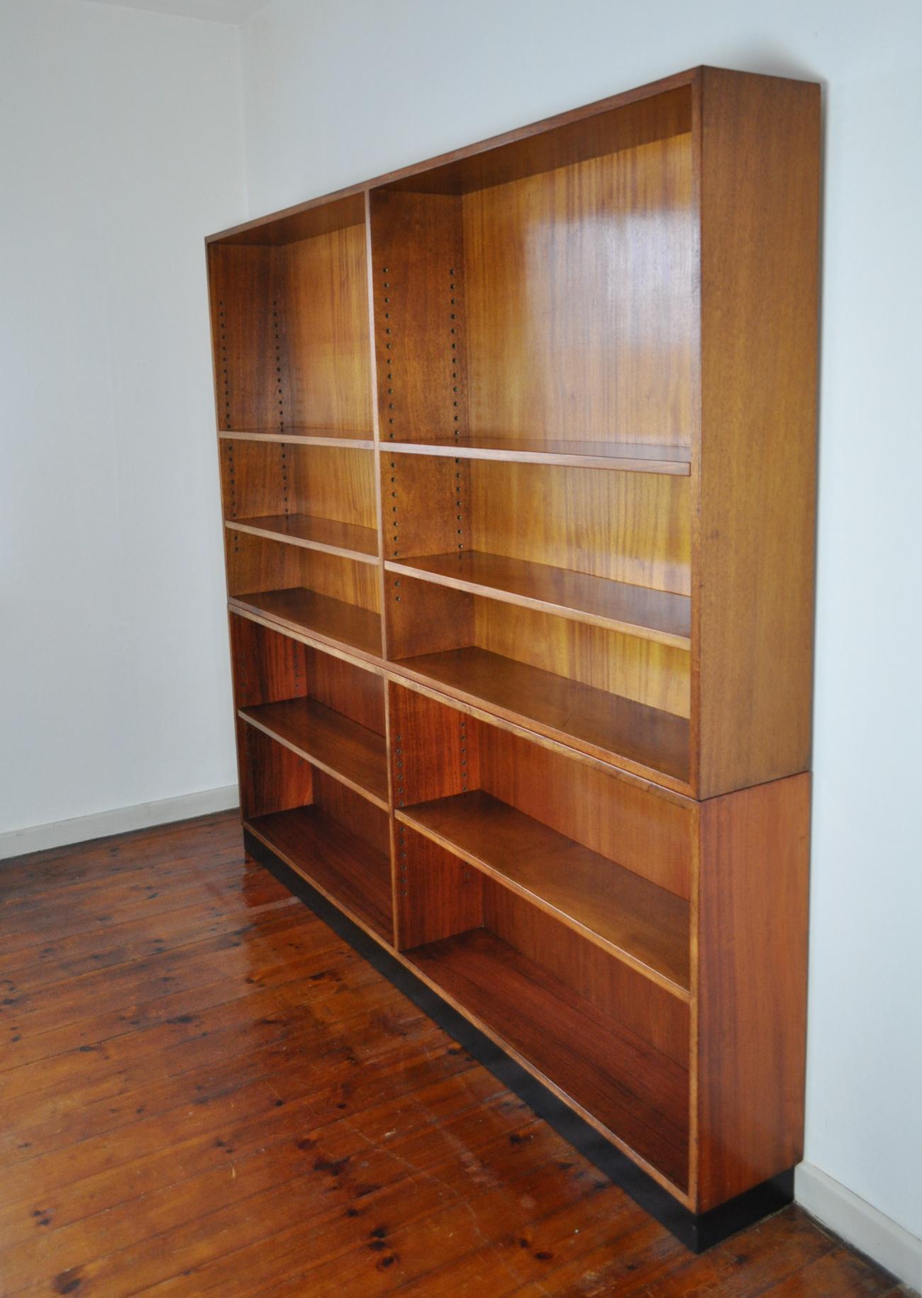 Large Rud. Rasmussen bookcase in two sections made of solid mahogany, bottom section on black painted base. Features 7 adjustable shelves, brass lined holes. Labeled by maker Rud Rasmussen. Height lower part 80, upper part 110 cm.

Very fine