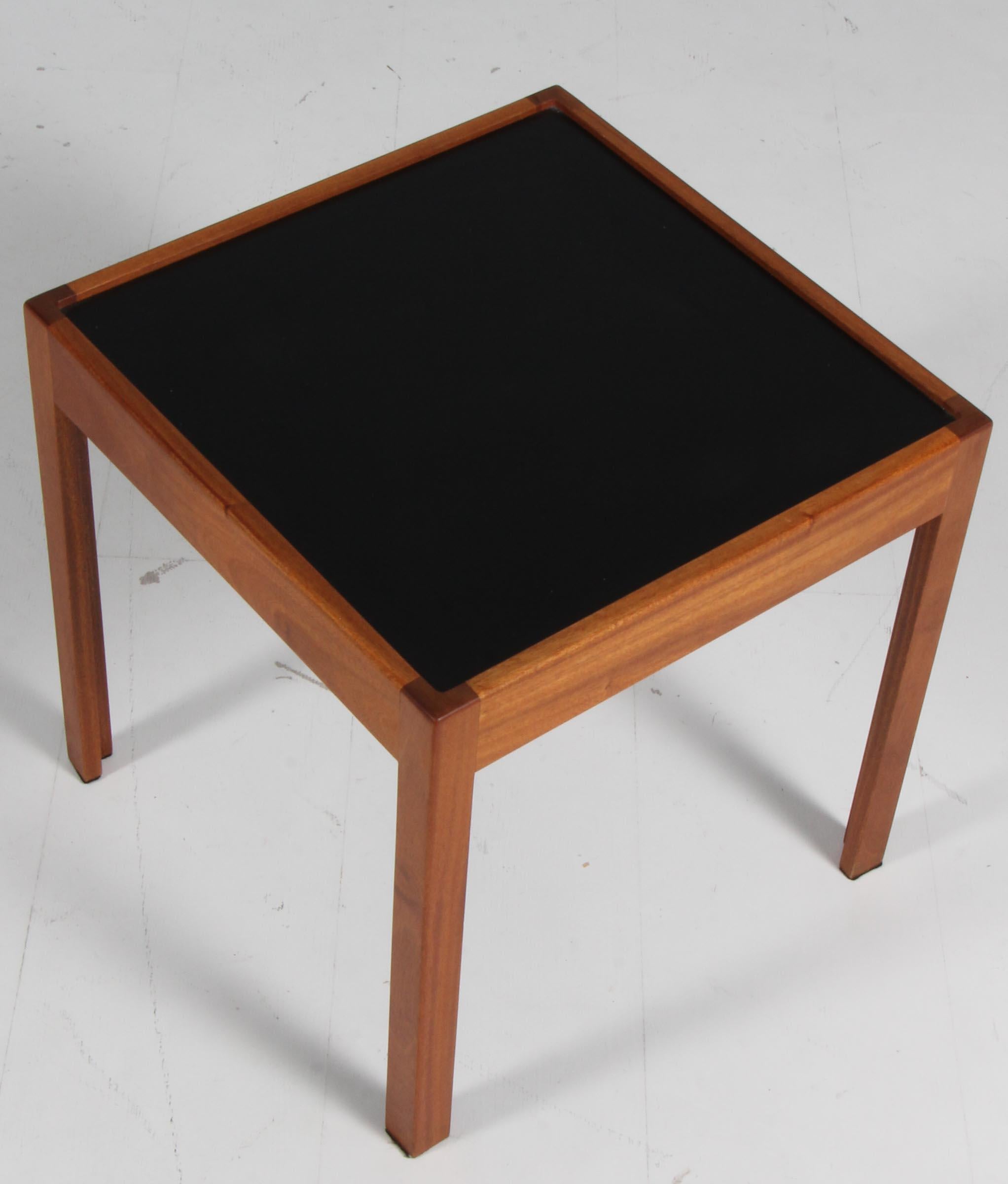 Side table of mahogany with top of black formica.
