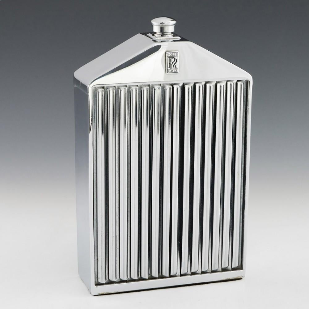 Heading : Ruddspeed Rolls Royce Radiator Decanter c1975 
Date : c1965 - 1985
Period : 20th century modern
Origin : Worthing, England
Decoration : Chrome plated facsimile of a Rolls Royce radiator grille, enclosing a glass decanter; black enamel