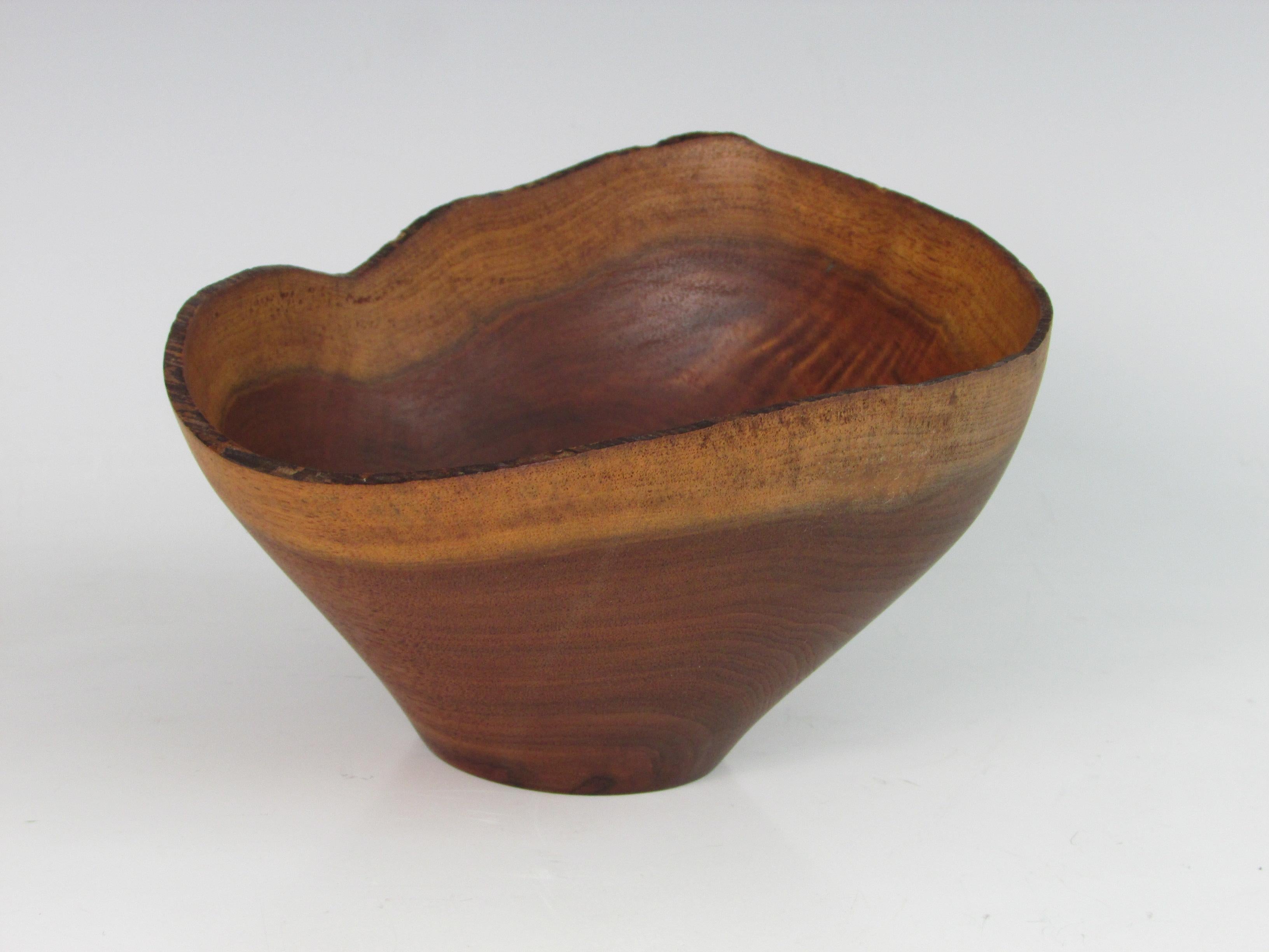 Nicely turned walnut bowl in wonderful form retaining live edge. Signed but signature is illegible.