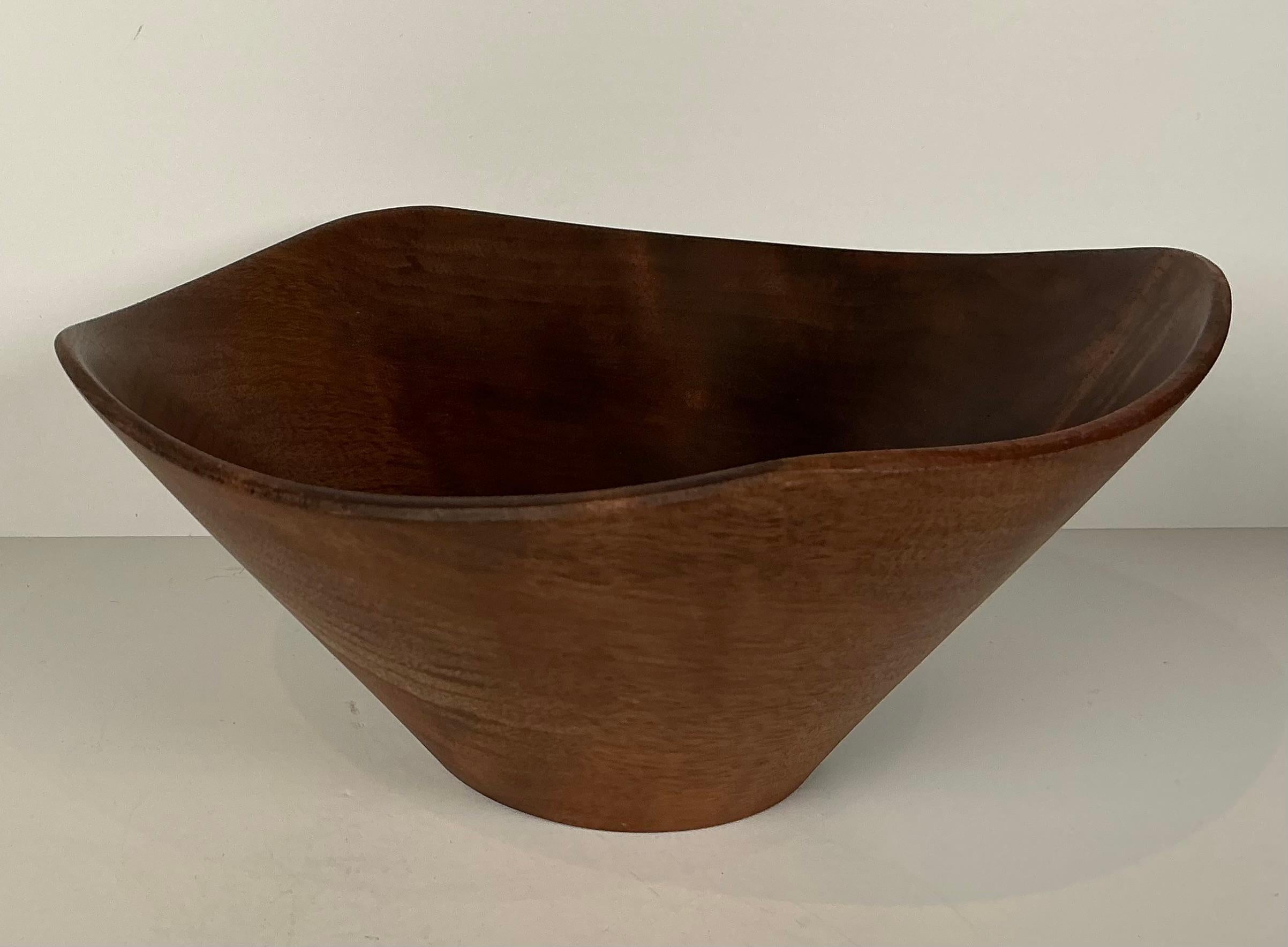 Rude Osolnik well known wood turner from Berea, Kentucky. 

Stunning asymmetrical form in walnut.  

Beautiful bowl.  Signed 