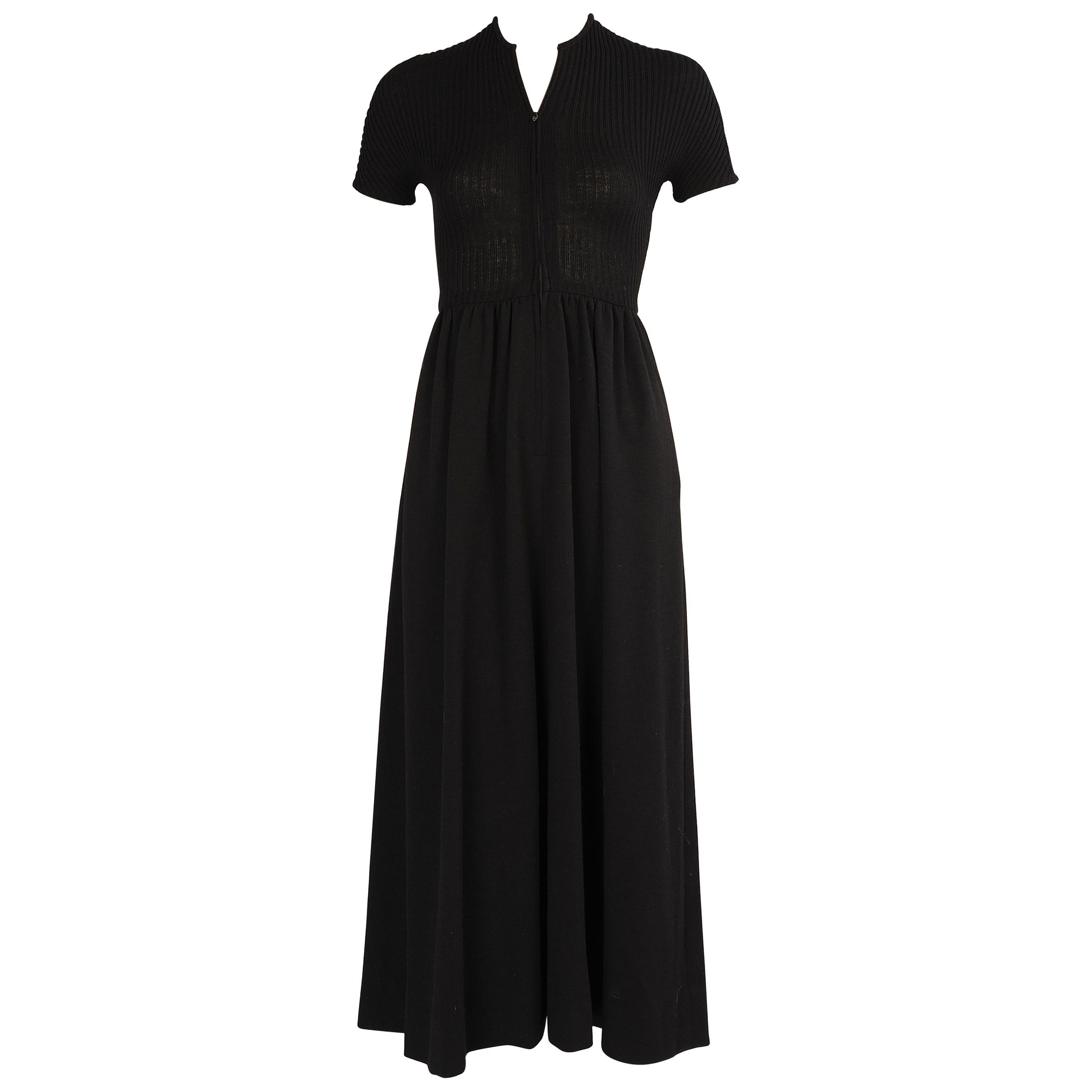 Rudi Gernreich is famous for designing the Topless Bathing Suit in the 1960's.  This dress looks so demure from the front with a wool knit with center zipper, short sleeves and a gathered skirt, but it is all about the back. The dress has a single