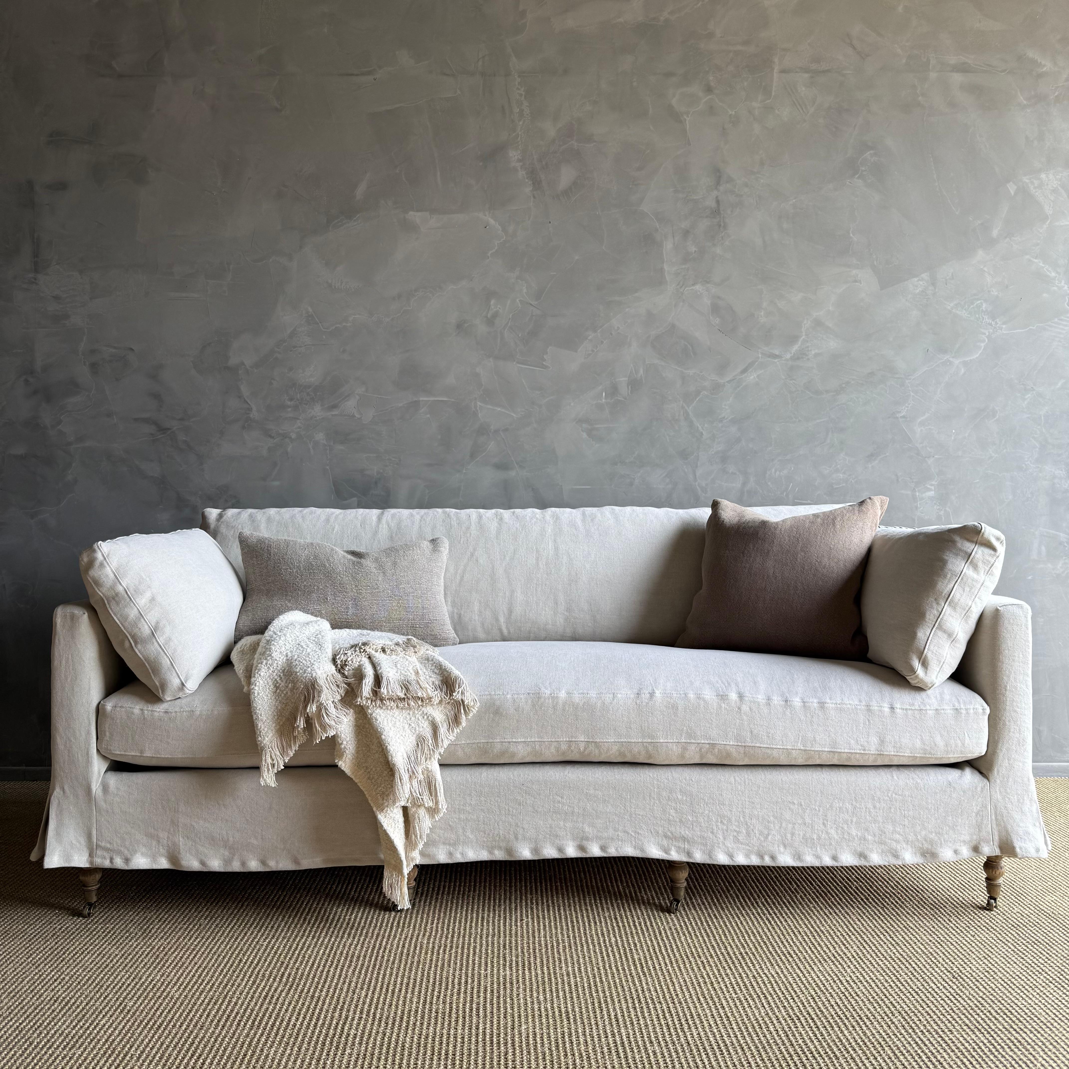 Bloom Home Inc Rudin Sofa Slip covered in Greige Stone Washed Linen

Stone Washed Linen A heavy 18 oz weighted linen, in a rich warm brown tone. Our linen is stone washed to give a soft hand and relaxed look. The seat is a down / feather wrapped