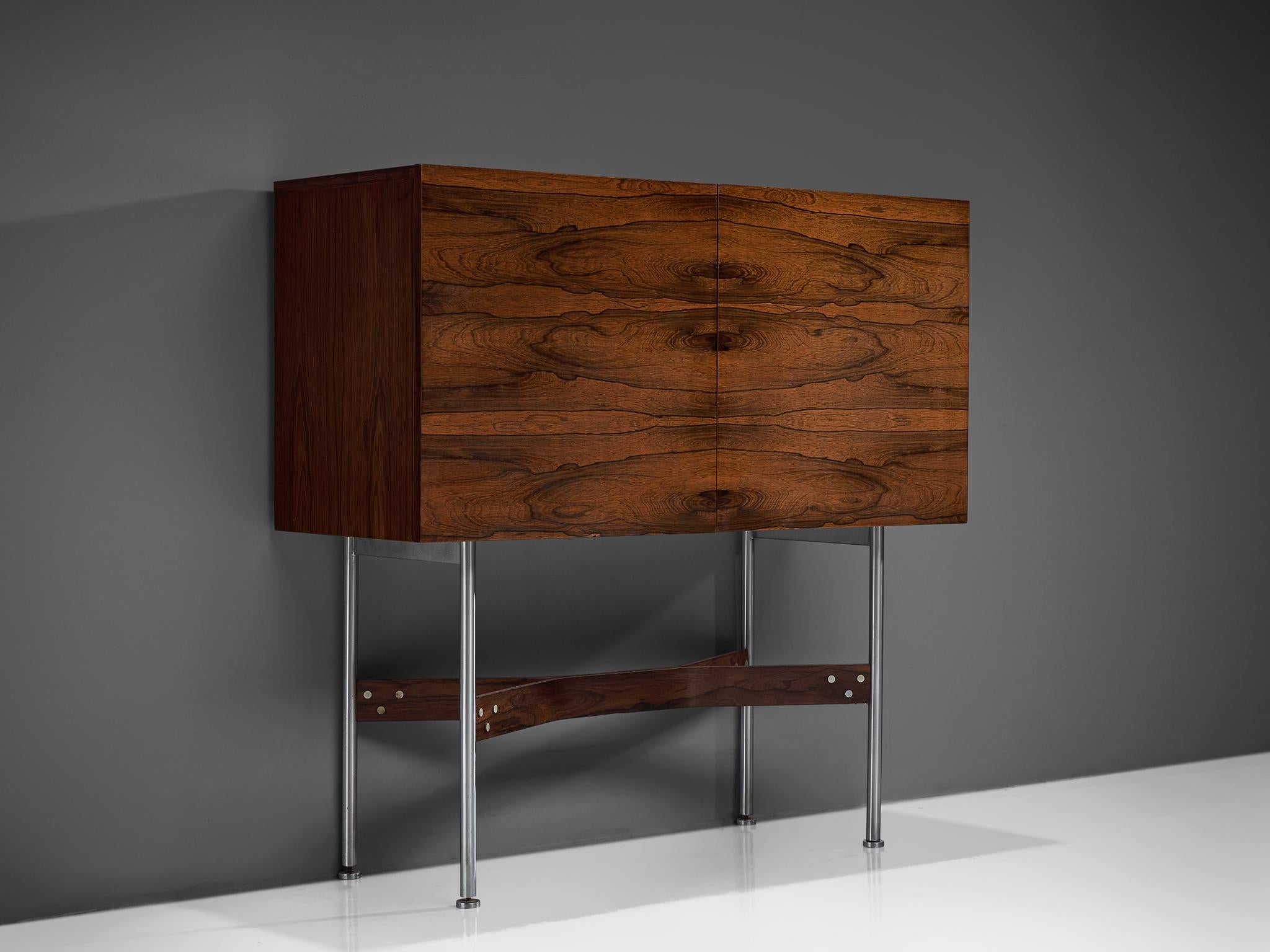Bar cabinet in rosewood and metal, by Rudolf Bernd Glatzel for Fristho Holland, the Netherlands, 1955.

Well-crafted bar cabinet with beautiful proportions. The elegant brushed metal and rosewood base contribute to the floating effect of the
