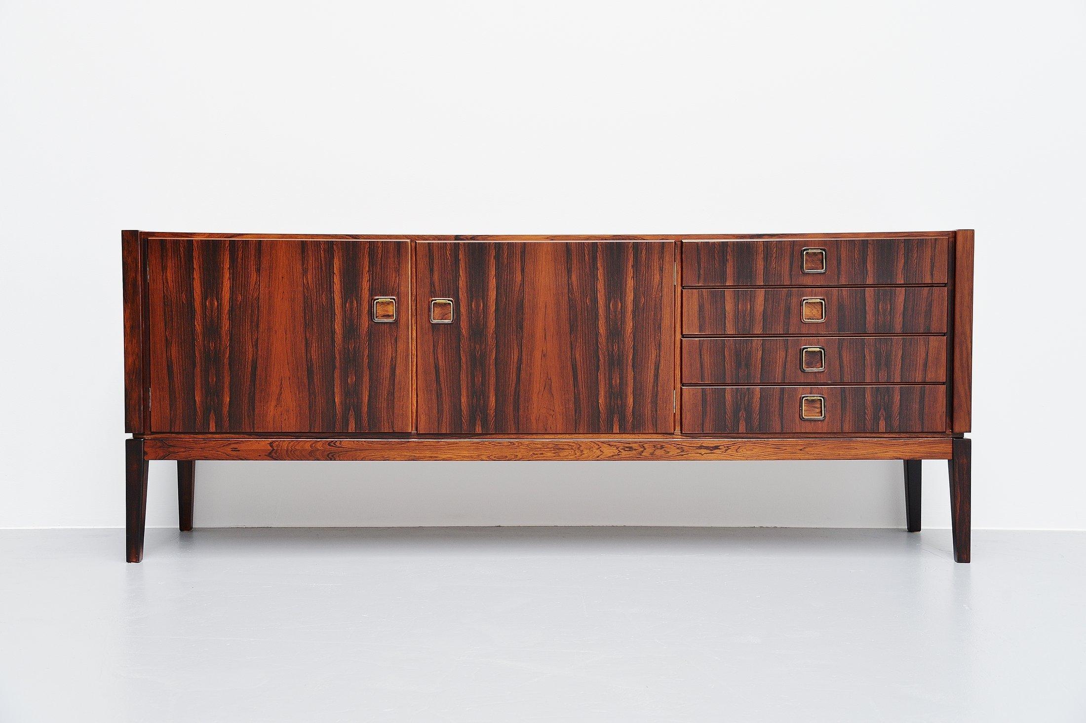 Nicely refined rosewood sideboard designed by Rudolf Bernd Glatzel and manufactured by Fristho Franeker, Holland, 1960. The sideboard has 2 folding doors with shelves behind on the left and on the right there are 4 drawers. The sideboard is fully