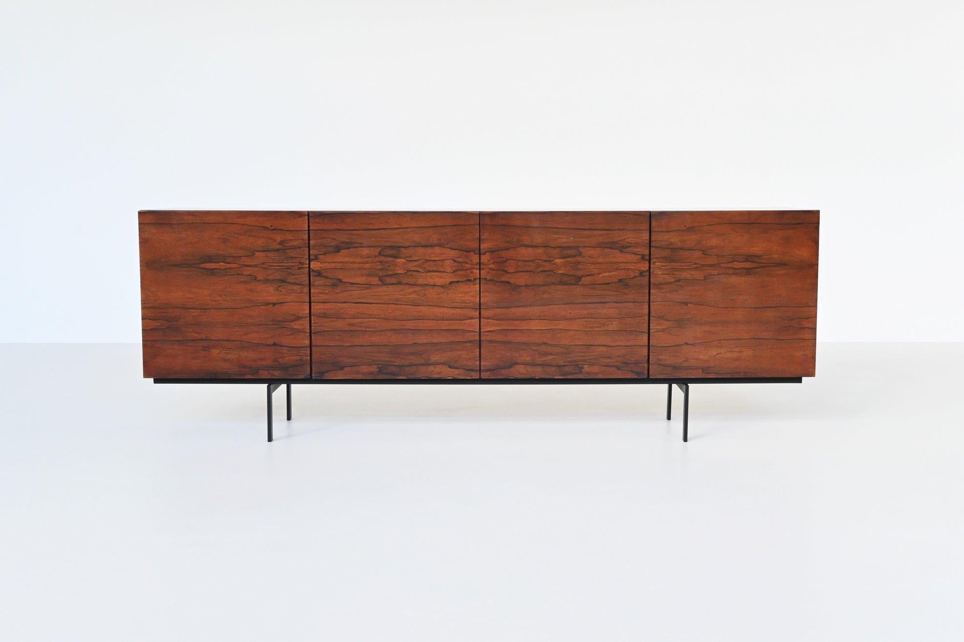 Stunning large sideboard designed by Rudolf Bernd Glatzel for Fristho Franeker, The Netherlands 1960. This well-crafted symmetric sideboard is made of beautiful grained rosewood and it has a black lacquered metal frame. It offers plenty of storage