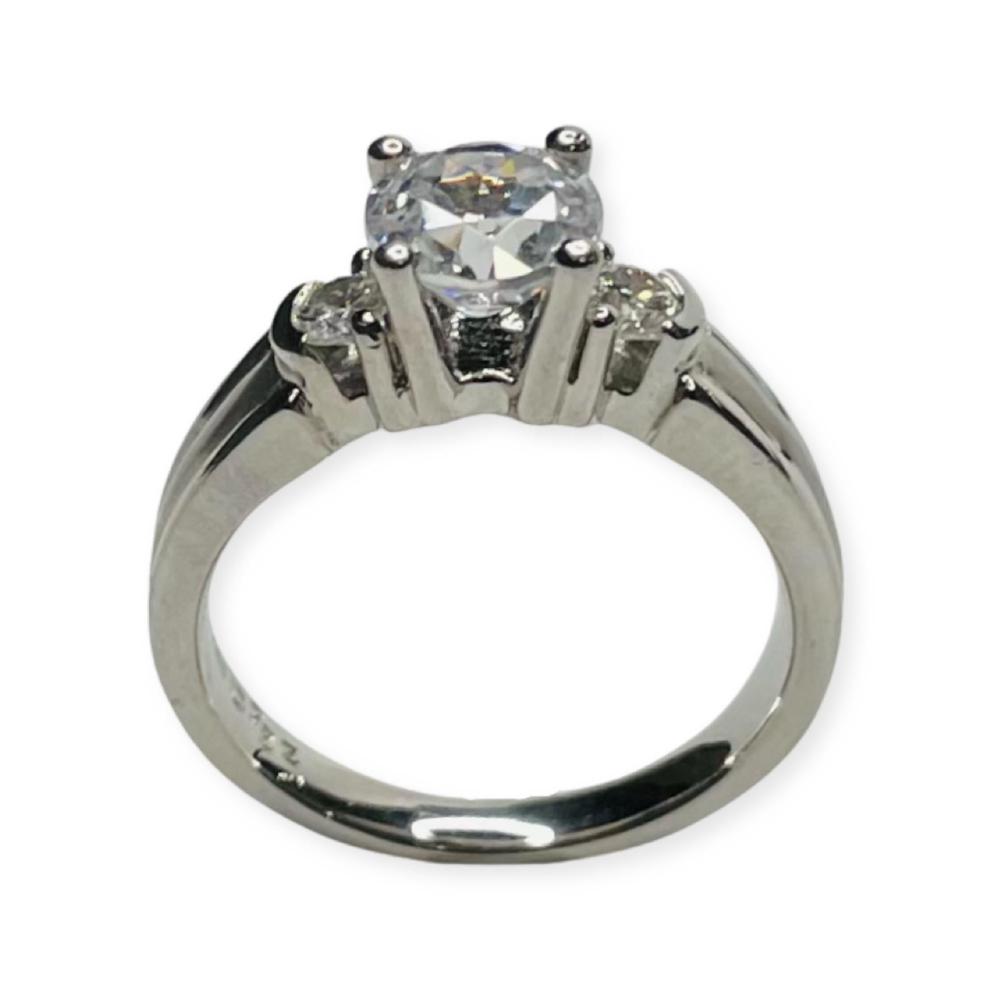 Rudolf Erdel Platinum and Diamond Engagement Ring. The side diamonds are 0.12 carat each for a total diamond weight of 0.24 carats. The diamonds are VS clarity and G Color. They are 2 prong and half bezel set. The CZ in the center is 6.5 mm which is