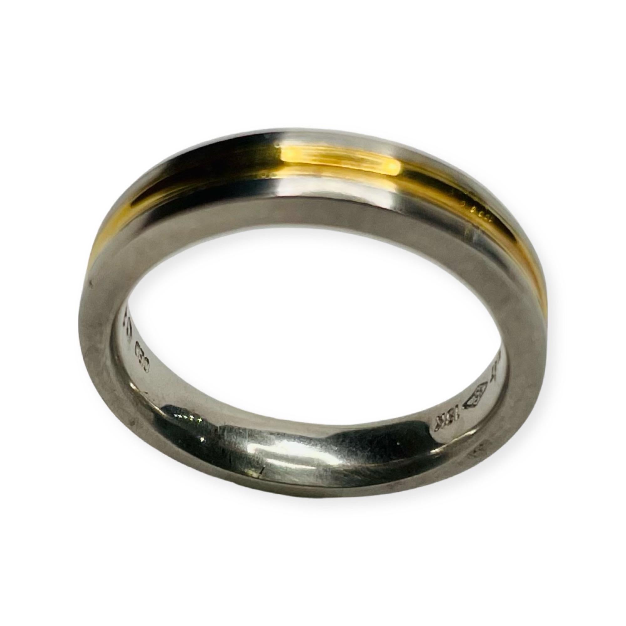 Rudolf Erdel Platinum & 18K Yellow Wedding Band. It is platinum with an 18K Yellow gold center. It is 3.88 mm at the top and 3.83 mm at the bottom of the shank.  It is Finger size 6 but can be sized for an additional charge. It has a high polish and