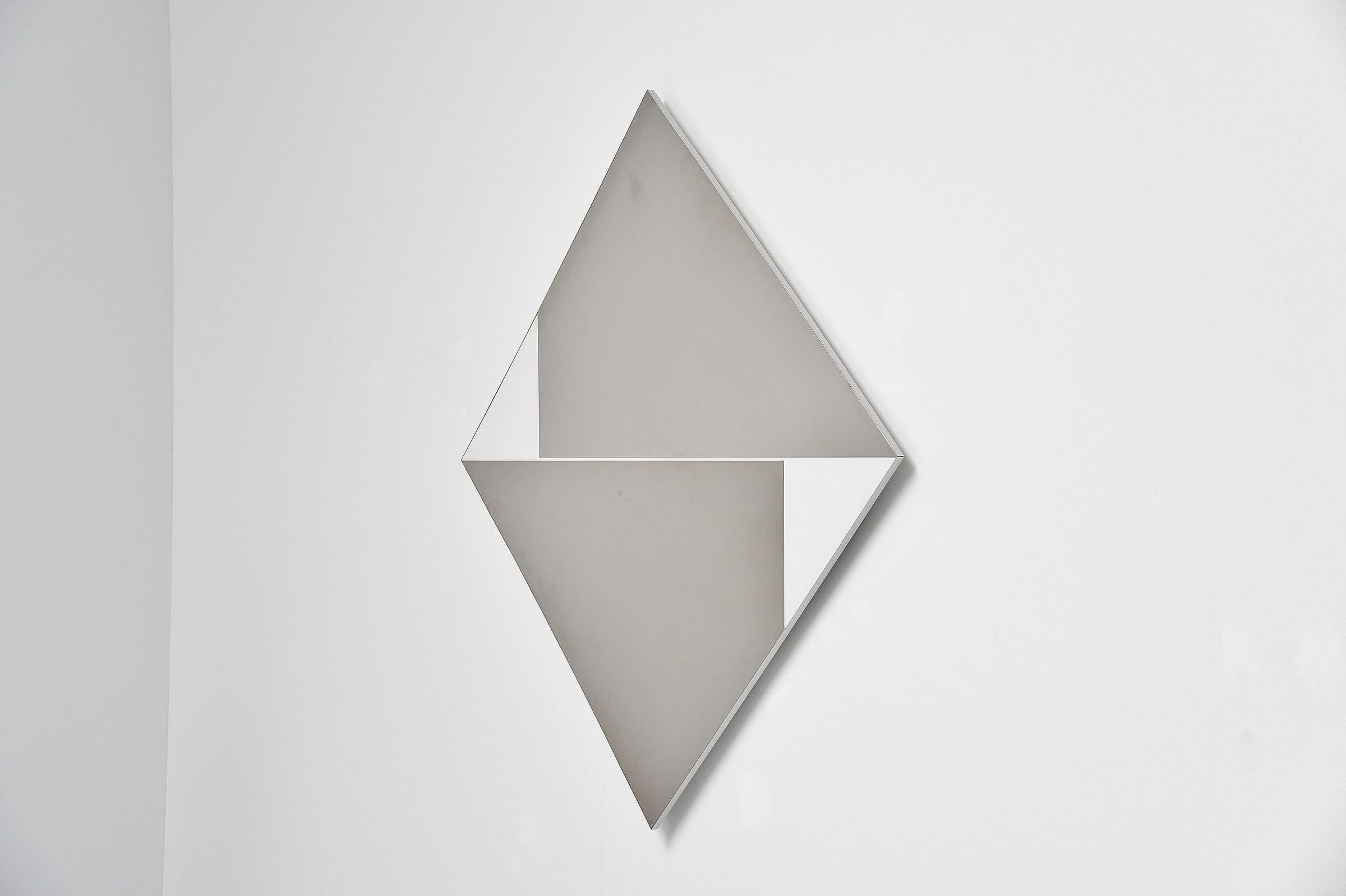 Stunning abstract modern triangle shaped stainless steel wall artwork designed by Rudolf Wolf and manufactured in his own atelier in 1972. This wall panel is made of white laminated board and has stainless steel abstract shapes on it. This artwork