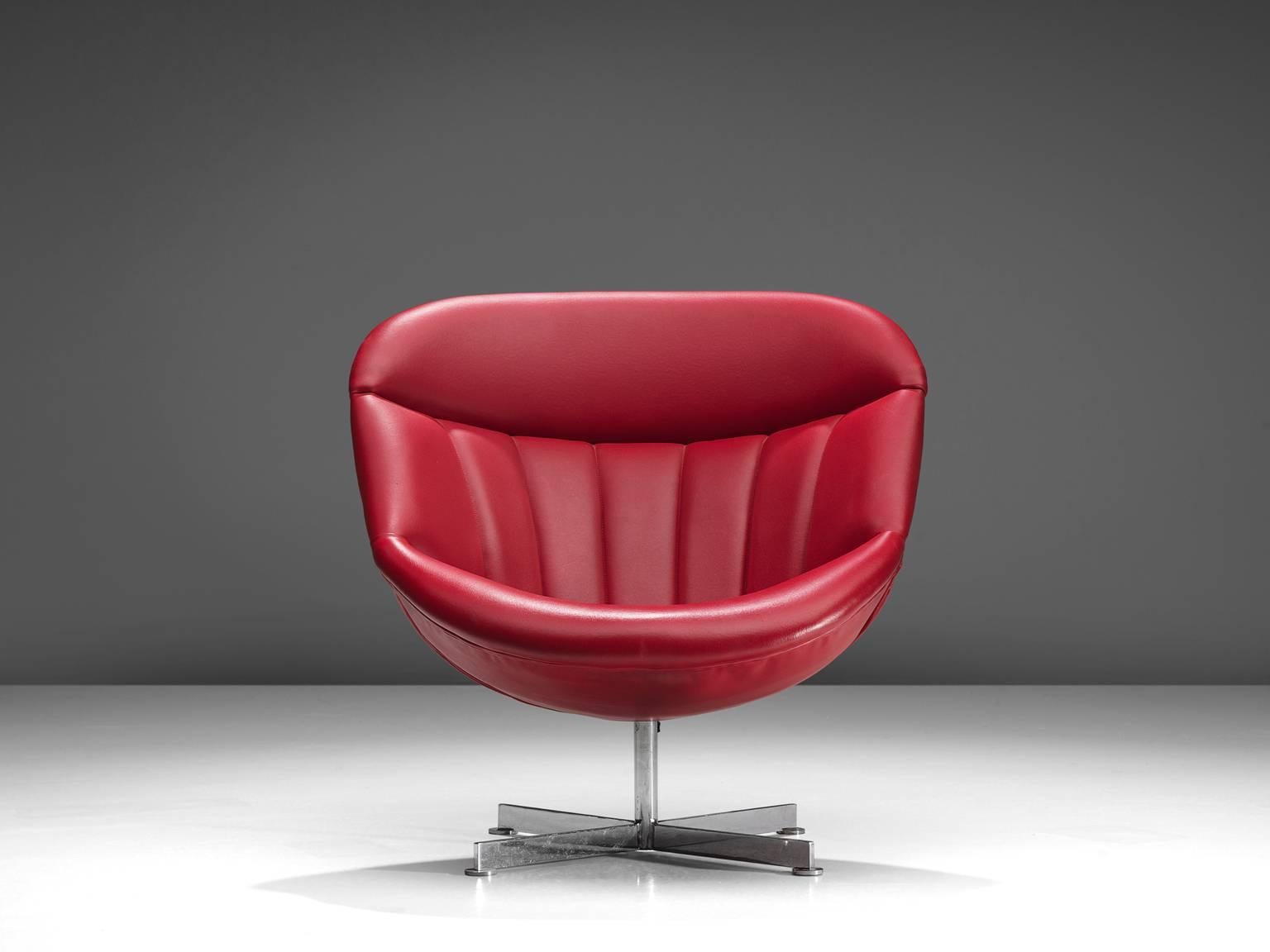 Rudolf Wolf for Rohe, lounge chair, metal and red faux-leather, the Netherlands, 1950s. 

This faux-leather red chair is both comfortable and aesthetically pleasing. The chair is equipped with a swivel base and the Ferrari red shell is padded.