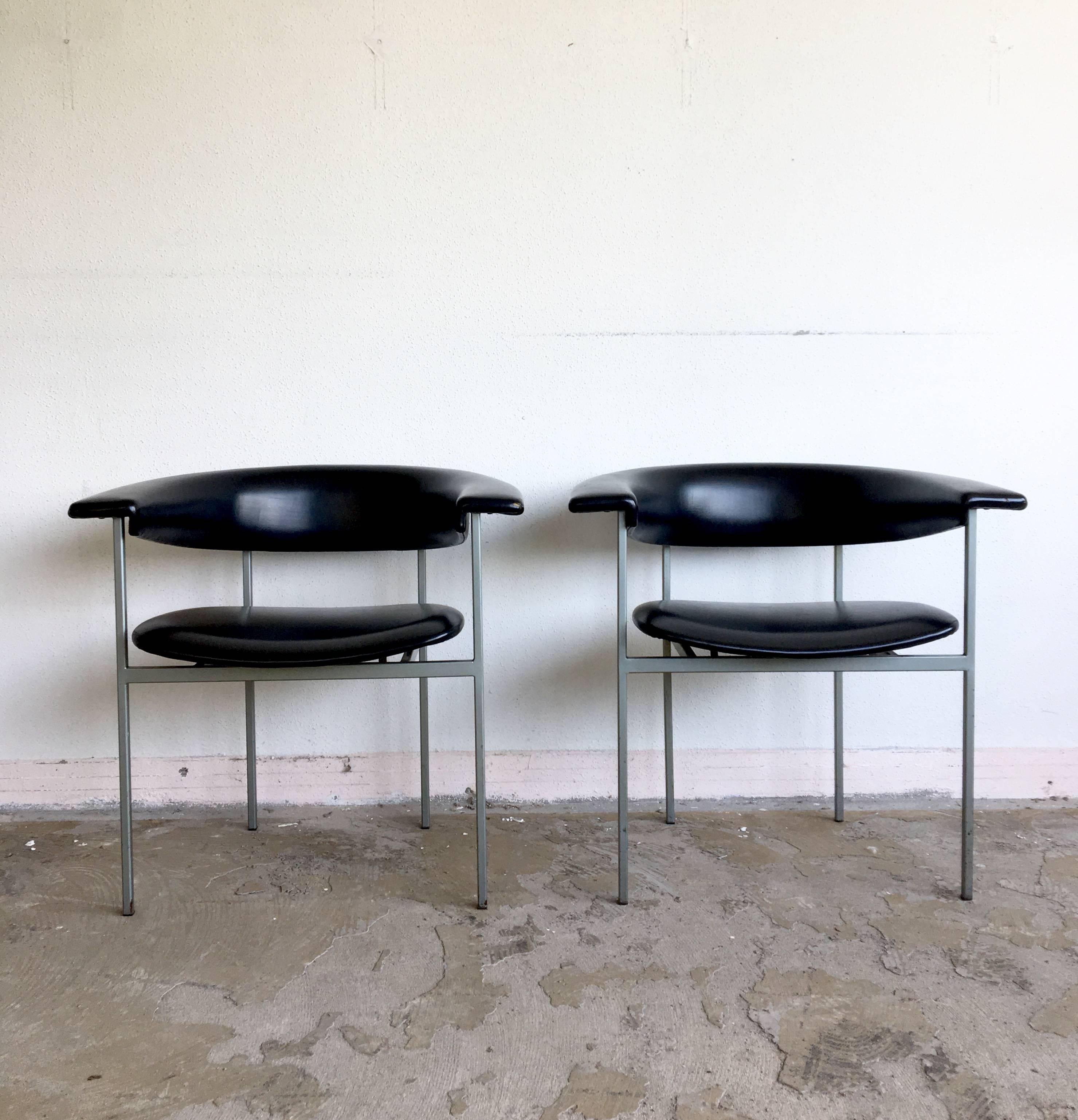 This pair of Dutch Minimalist armchairs were designed by Rudolf Wolf for Gaasbeek-Van Tiel in the early 1960s. The chairs come from the Meander series and feature a grey metal base with Black faux leather upholstery. The Gamma Club chair was named,