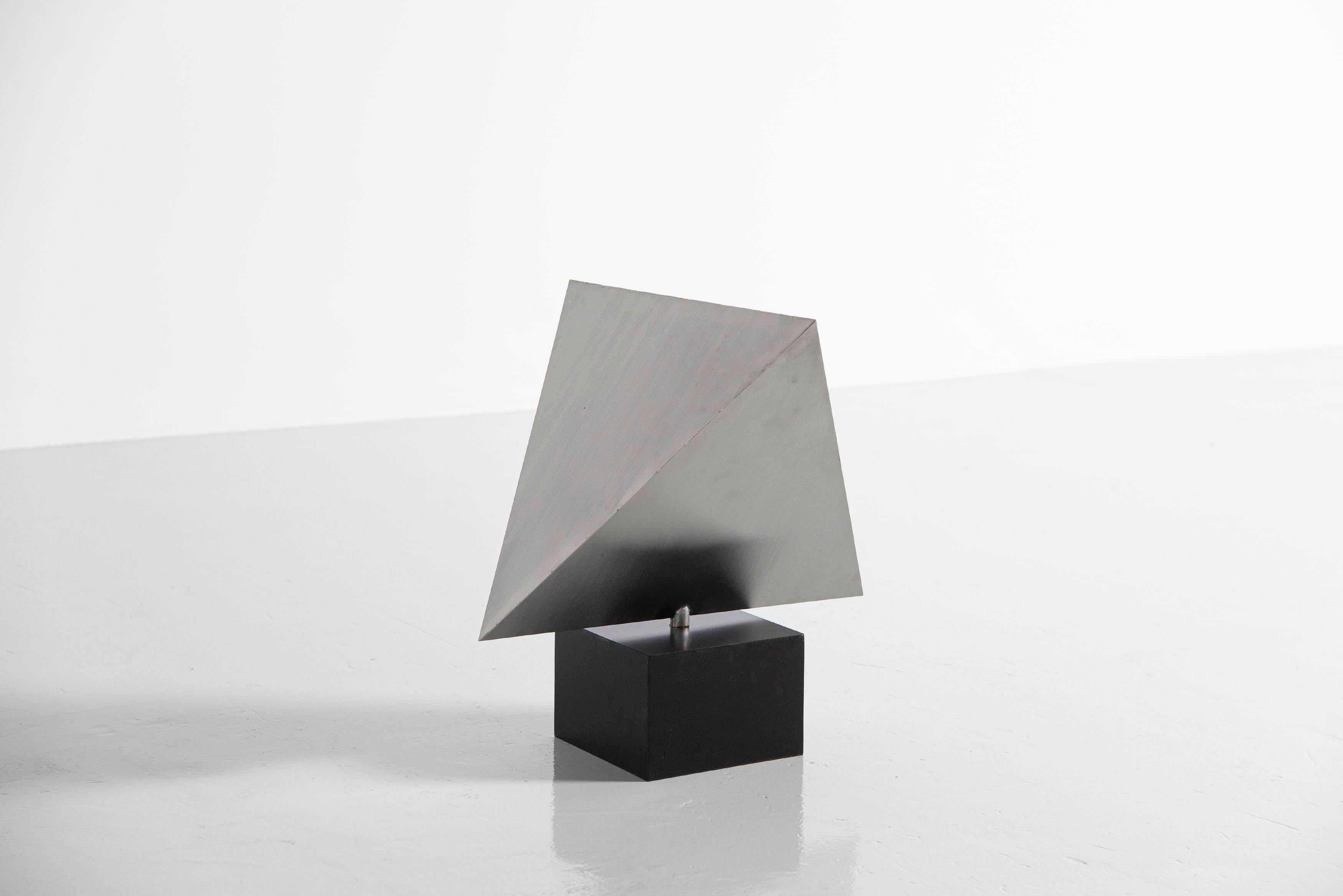 Very nice and large geometric sculpture designed by Rudolf Wolf and manufactured in his own atelier ca 1975. This sculpture is made of stainless steel and has a black painted wooden base. This sculpture is one of several we acquired from the former