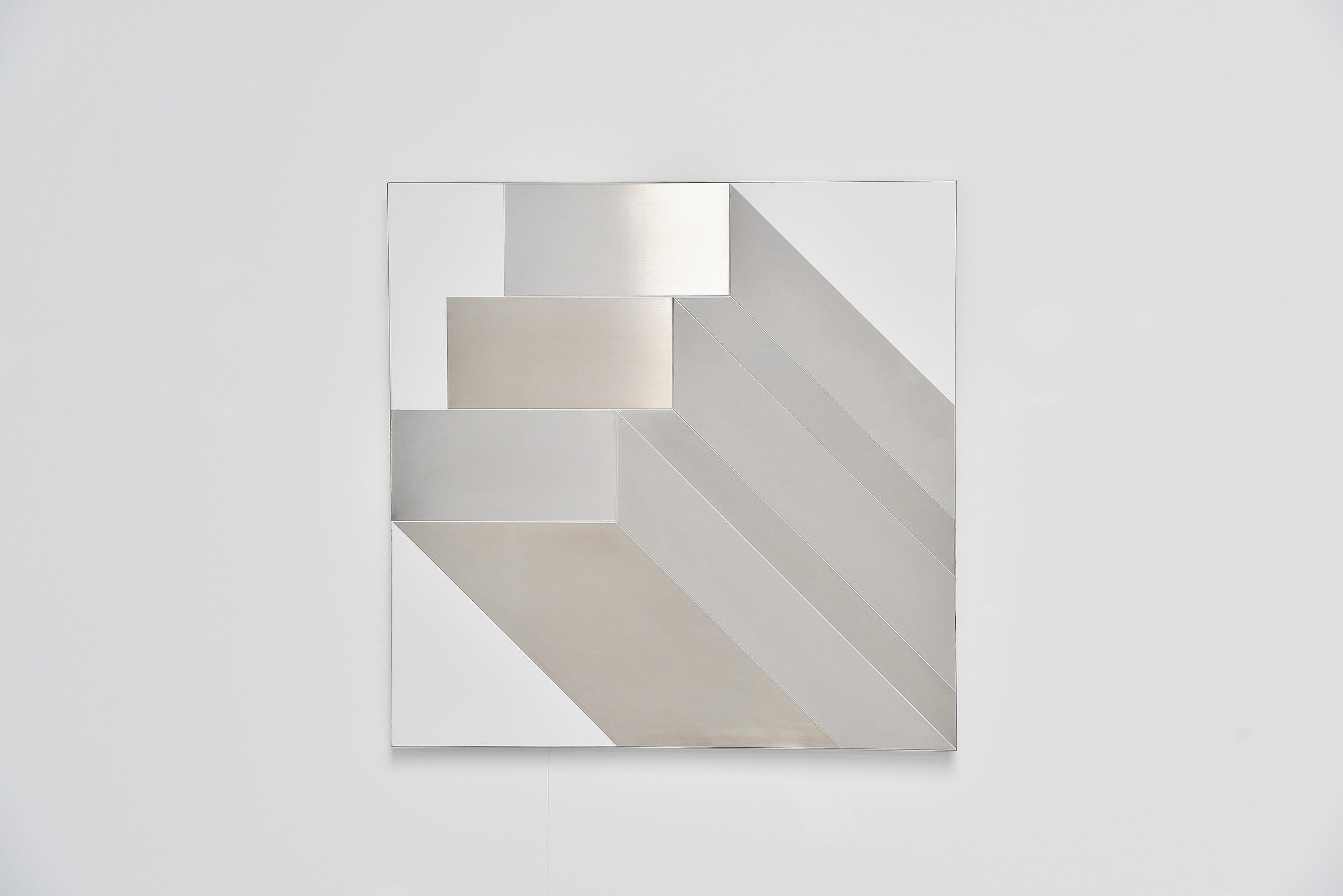 Large abstract modern shaped stainless steel wall artwork designed by Rudolf Wolf and manufactured in his own atelier in 1972. This wall panel is made of white laminated board and has a stainless steel abstract configuration on it. This artwork is 1