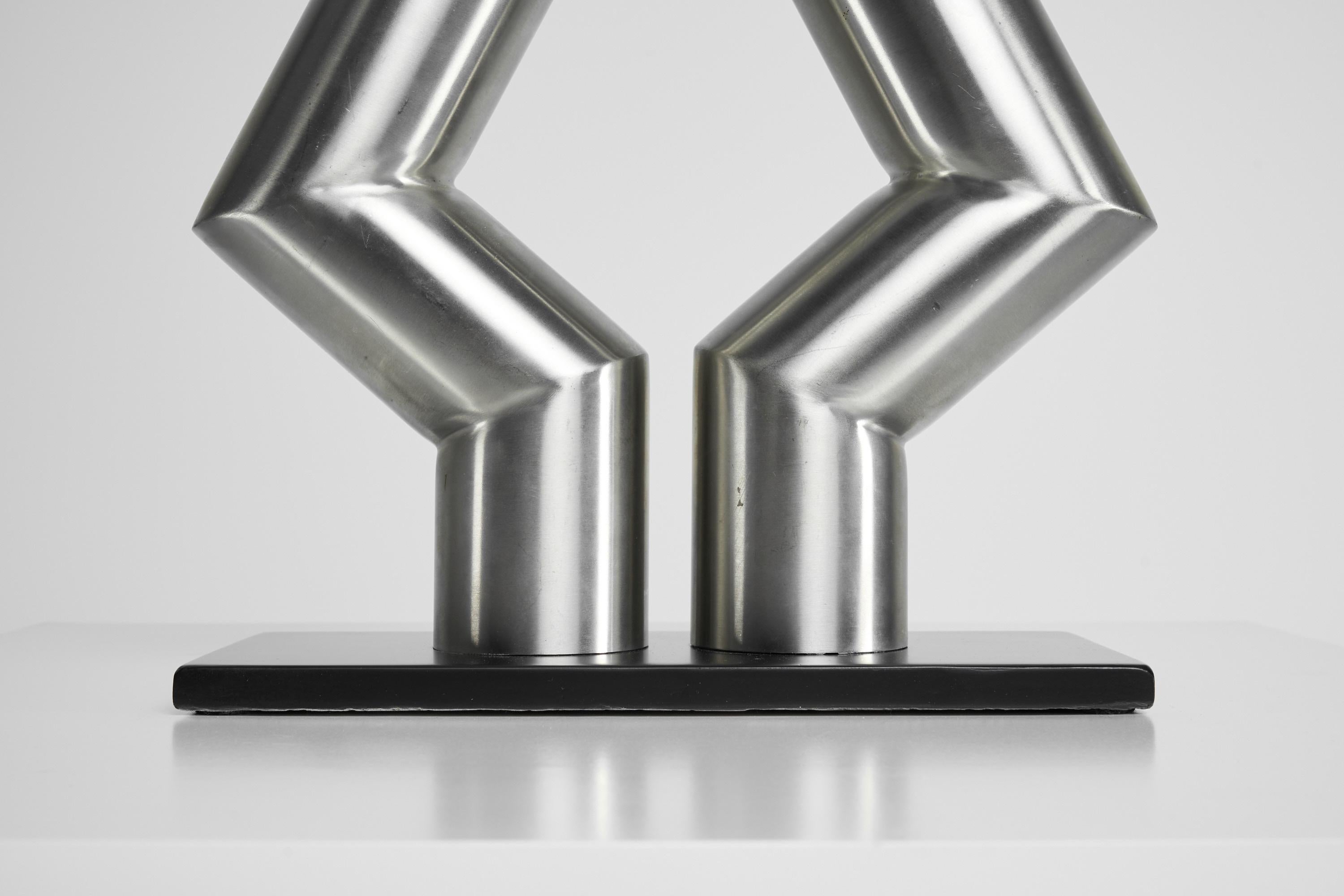 Stunning sized symmetrical sculpture in stainless steel, designed and made by Rudolf Wolf in his own atelier in Amstelveen in 1975. The sculpture is made of 2 stainless steel tubes, cut, and welded perfectly into this abstract modern shape; it has a
