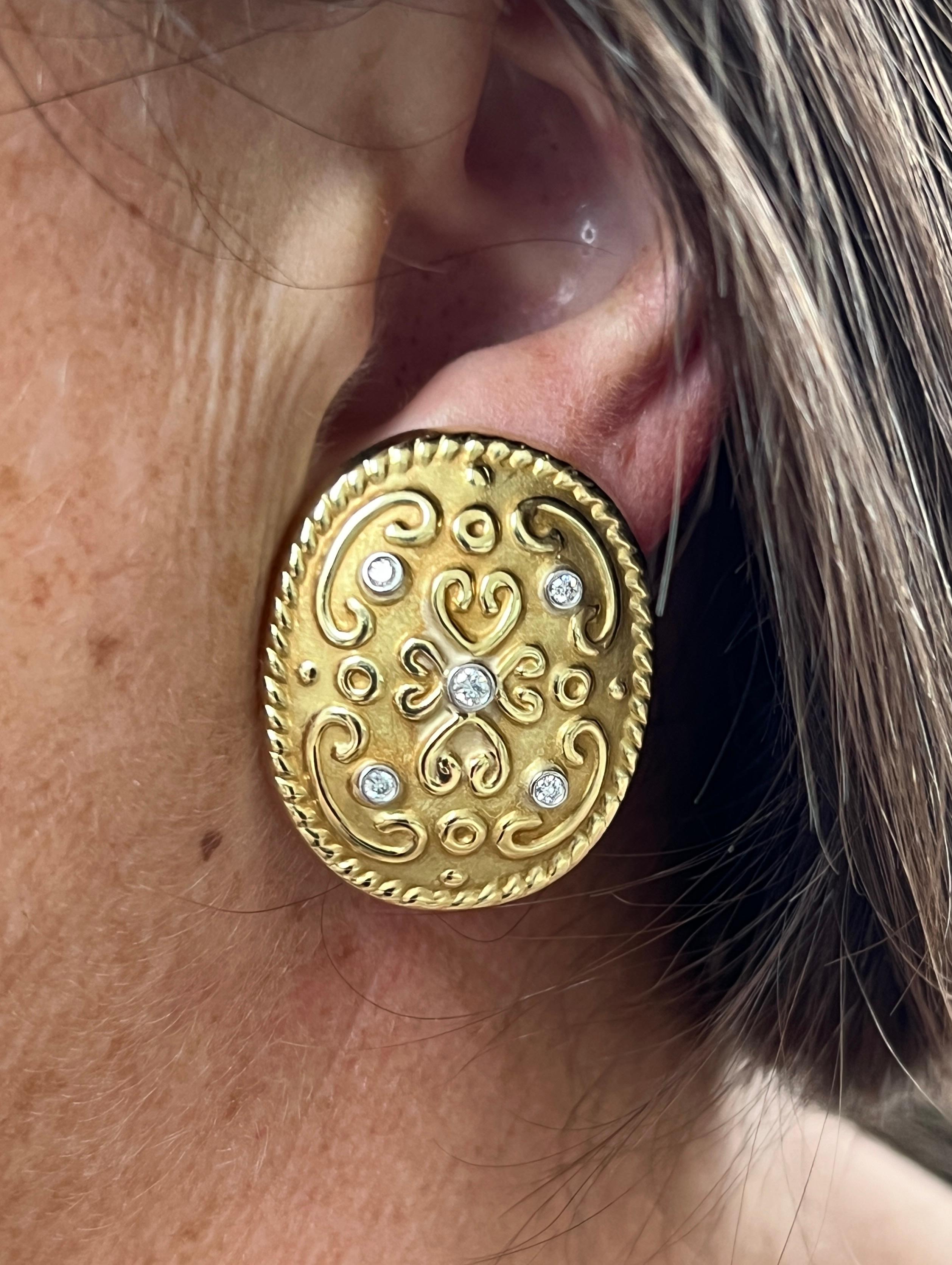 One pair of  18k yellow gold Fleur-de-Lis earrings by Rudolph Friedmann featuring a delicate sandblast and high-polish relief finish. The are adorned with ten full-cut H/SI2 diamonds ranging from 1.5mm to 2.5mm, totaling 0.35 carats, these earrings