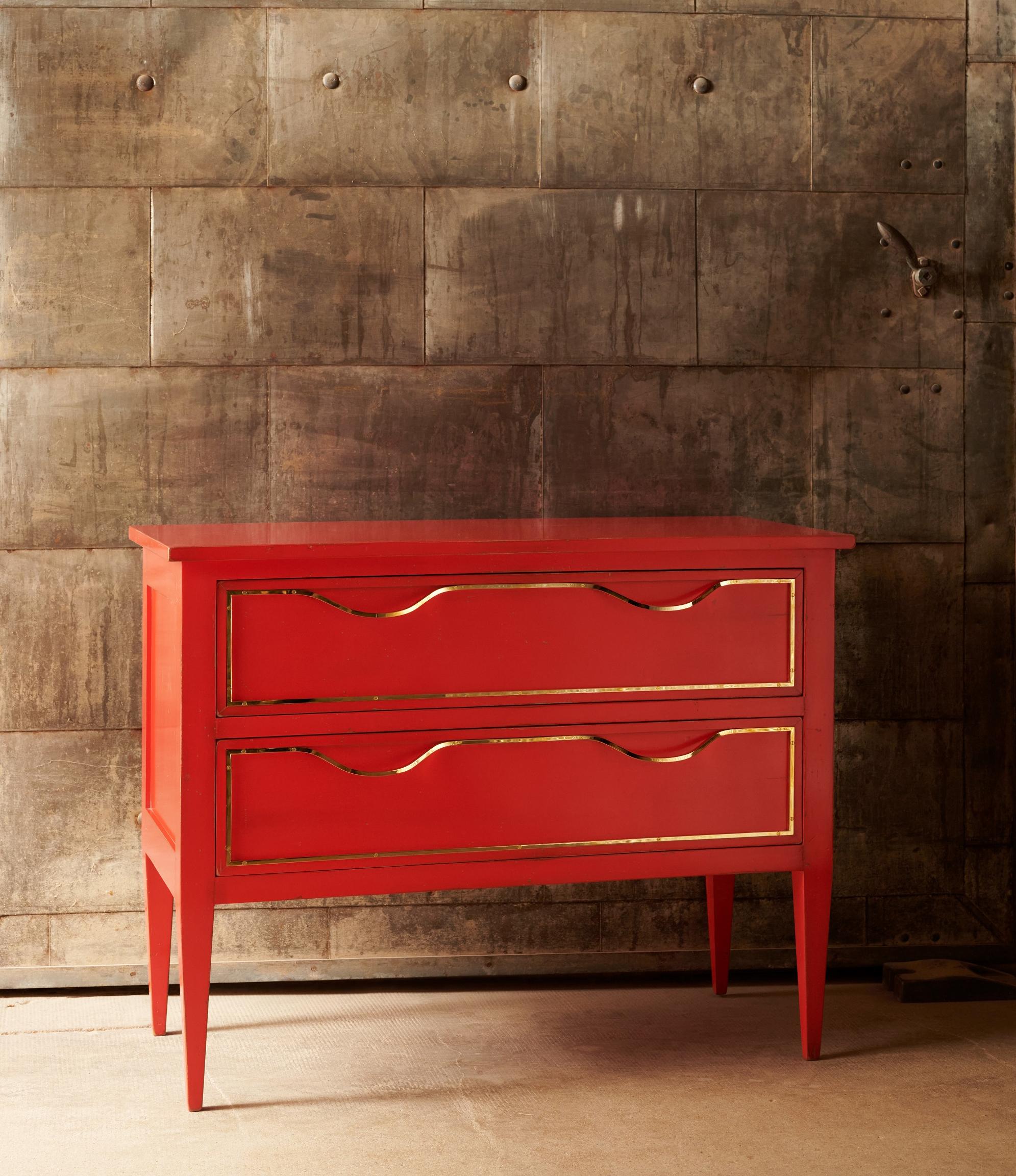 Géranium lacquered beech chest-of-drawers with two drawers with polished brass frame handle. 
It is a piece of furniture made by hand by the craftsmen of Moissonnier, French cabinetmaker since 1885. Our craftsmen use ancestral know-how and have