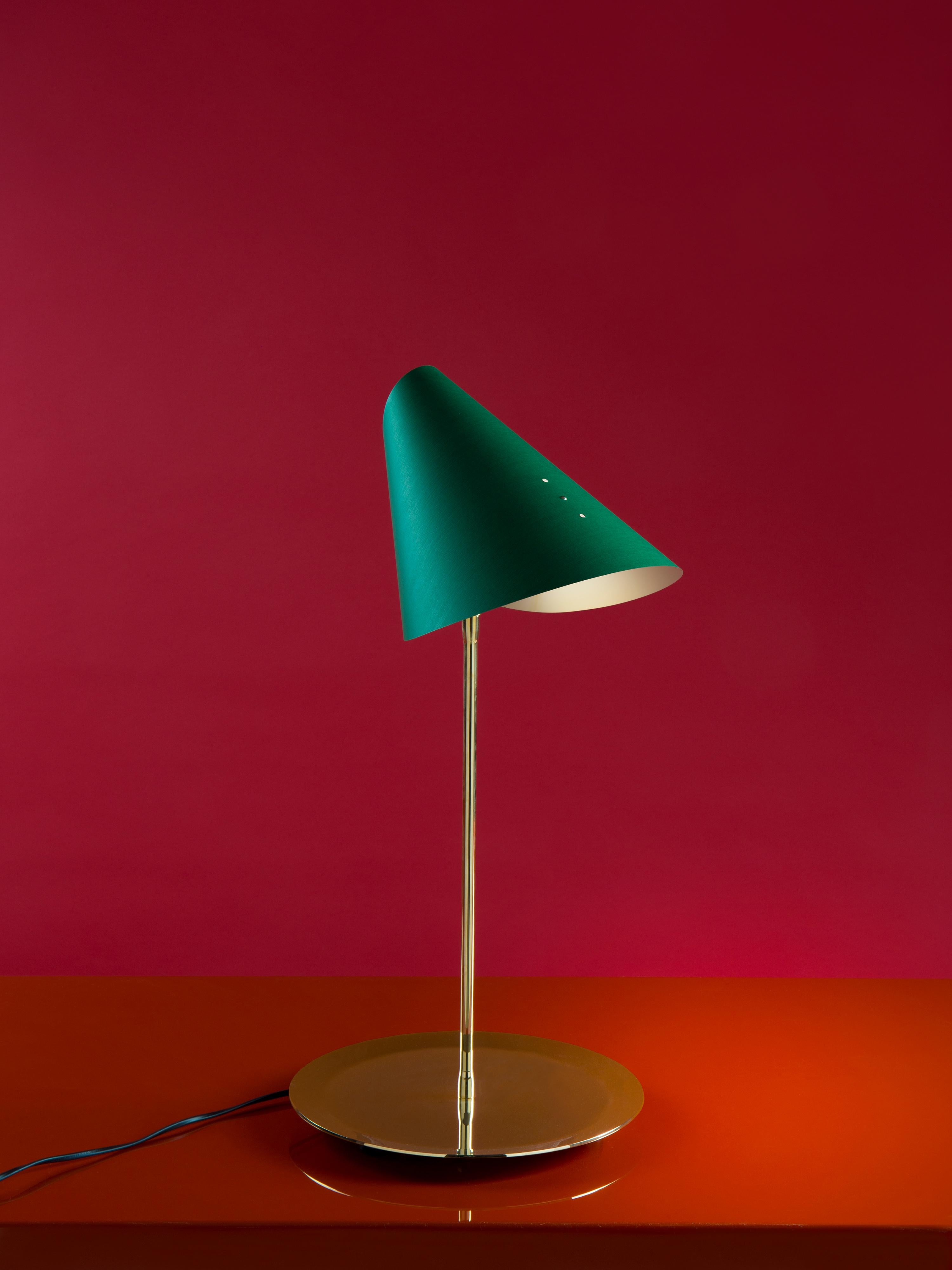 Designed in 1972 - Paradisoterrestre Edition

Materials: brass-plated metal structure, cardboard canvas light diffuser

Colours: diffuser in white, black, green, blue

“A flash of joy and poetry. The simplest directional lampshade in history