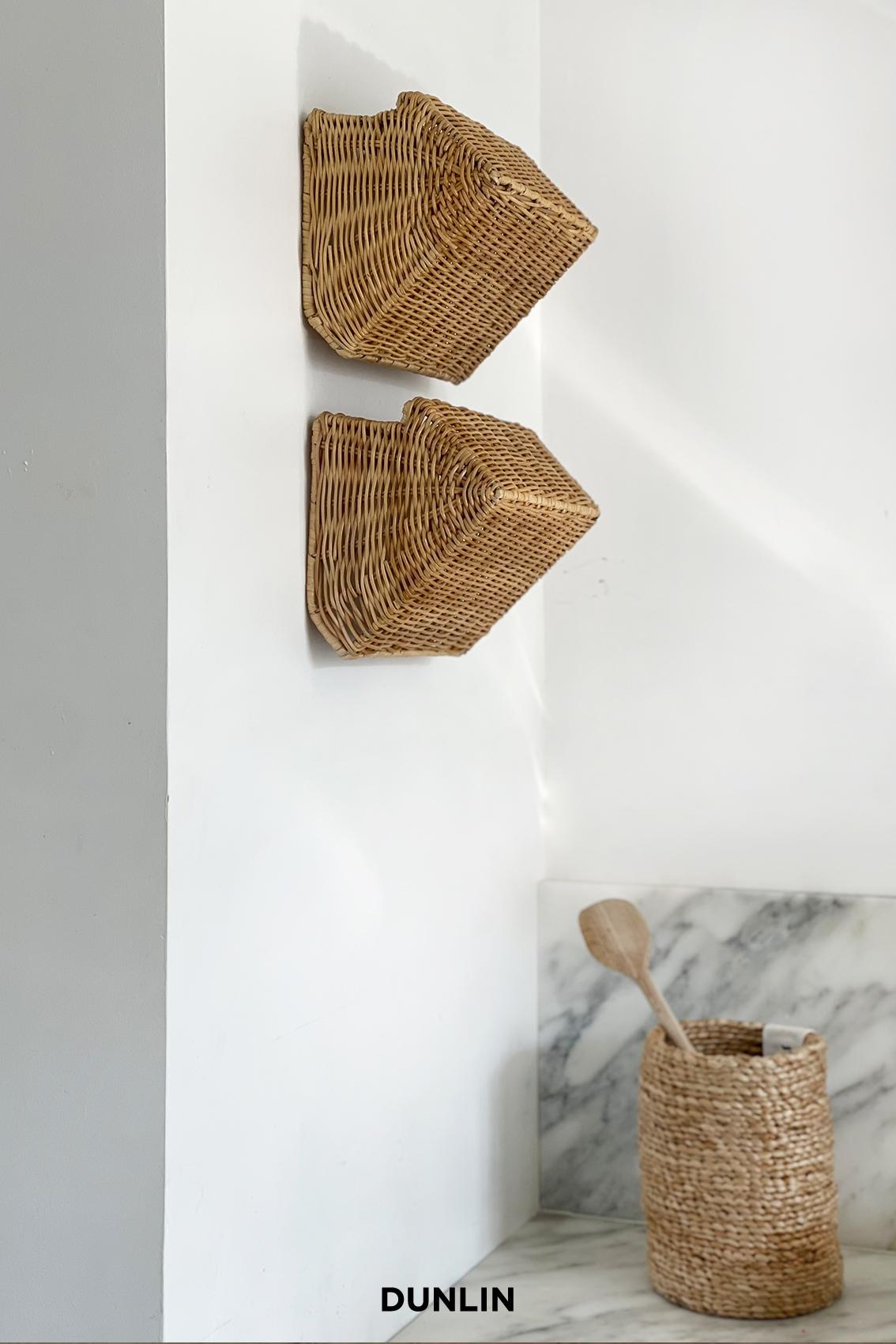 Handwoven Rattan in Indonesia. 
Designed by Dunlin.

An elegant, perfectly proportioned rattan wall sconce designed by Dunlin. Timeless in form and impeccable in execution, these are ideal sconces to frame artwork, crown a fireplace or run along a
