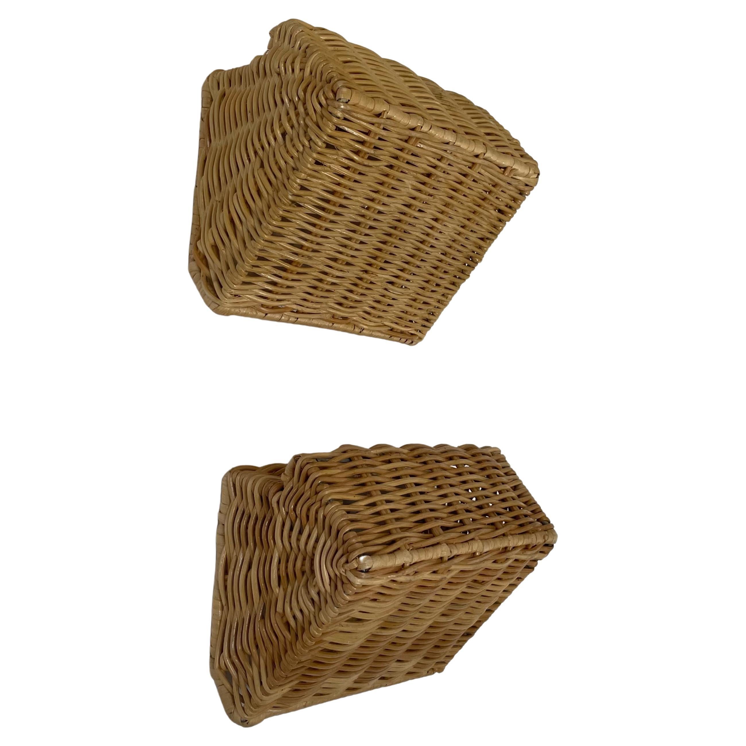 An elegant, perfectly proportioned rattan wall sconce designed by Dunlin. Timeless in form and impeccable in execution, these are ideal sconces to frame artwork, crown a fireplace or run along a corridor. Handmade rattan in a unique Dunlin weave.
