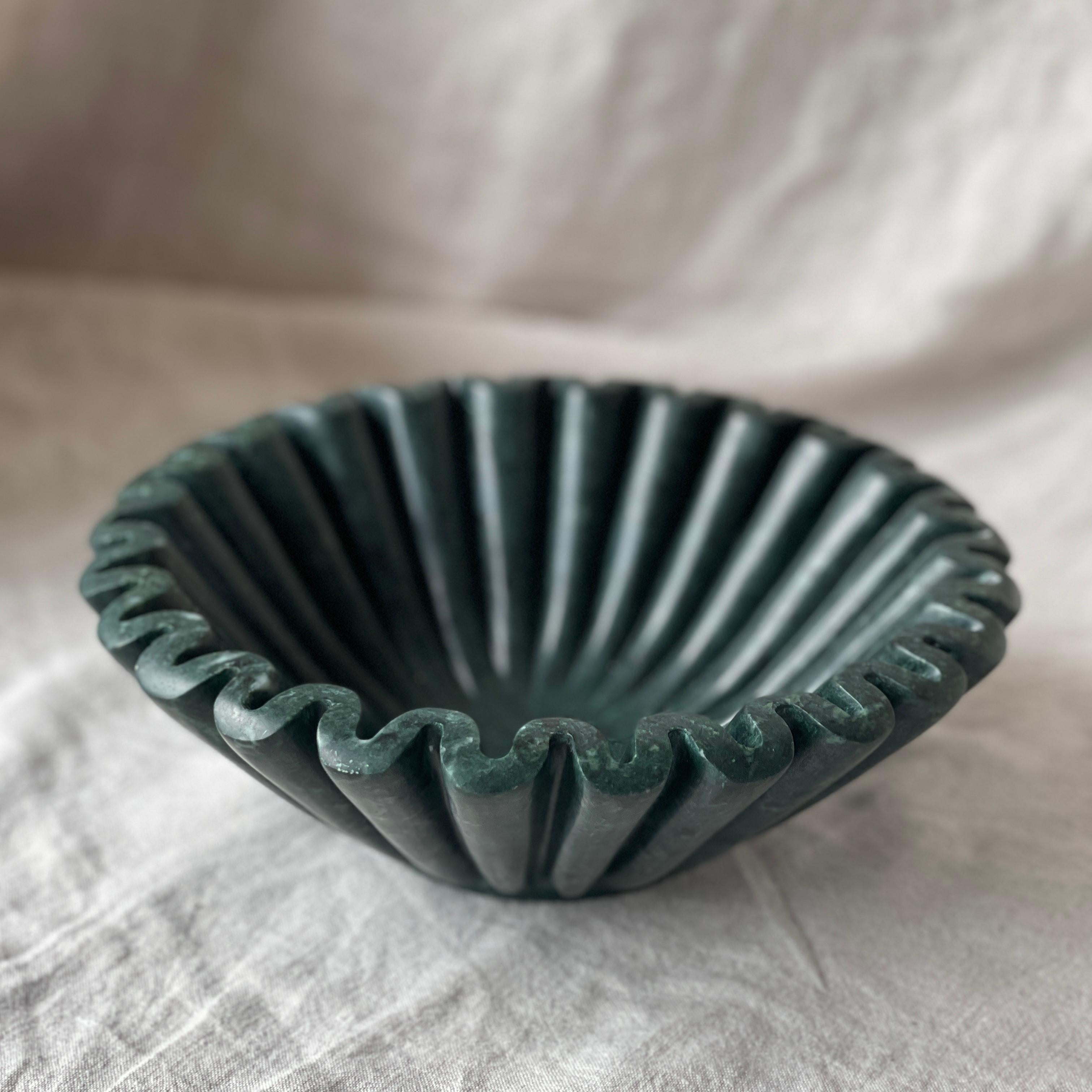 Ruffle Bowl is a limited edition functional object d'art carved from a single cube of Dark Green Emerald Marble. Hand-finished by a growing artisan atelier in Rajasthan, India it is produced exclusively by Anastasio Home. With its gently folded