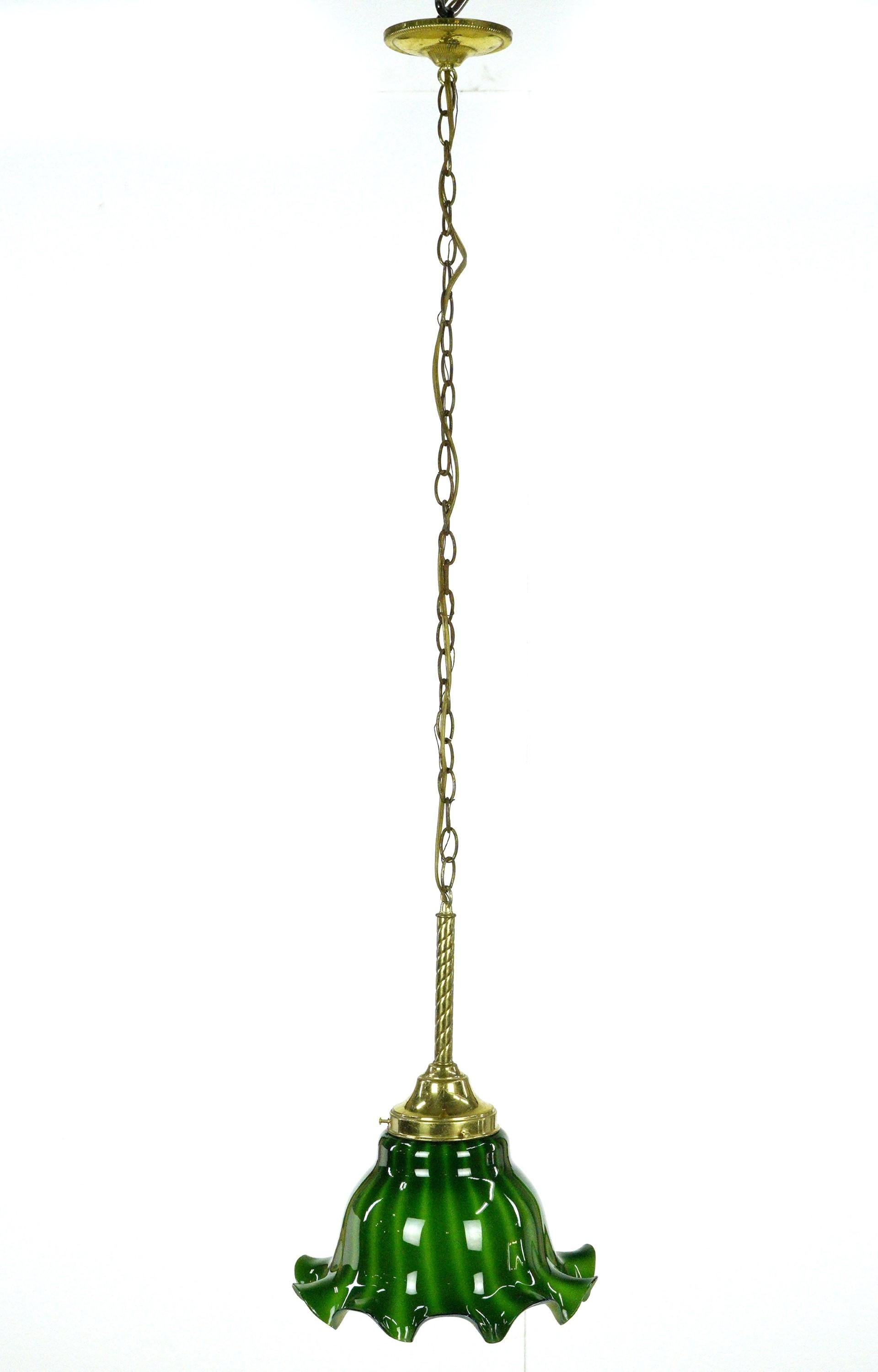 Pendant light with a ruffled green glass shade and a brass chain fitter. This requires one standard medium base bulb. The price includes restoration of cleaning and rewiring. Good condition with appropriate wear from age. One available. Cleaned and