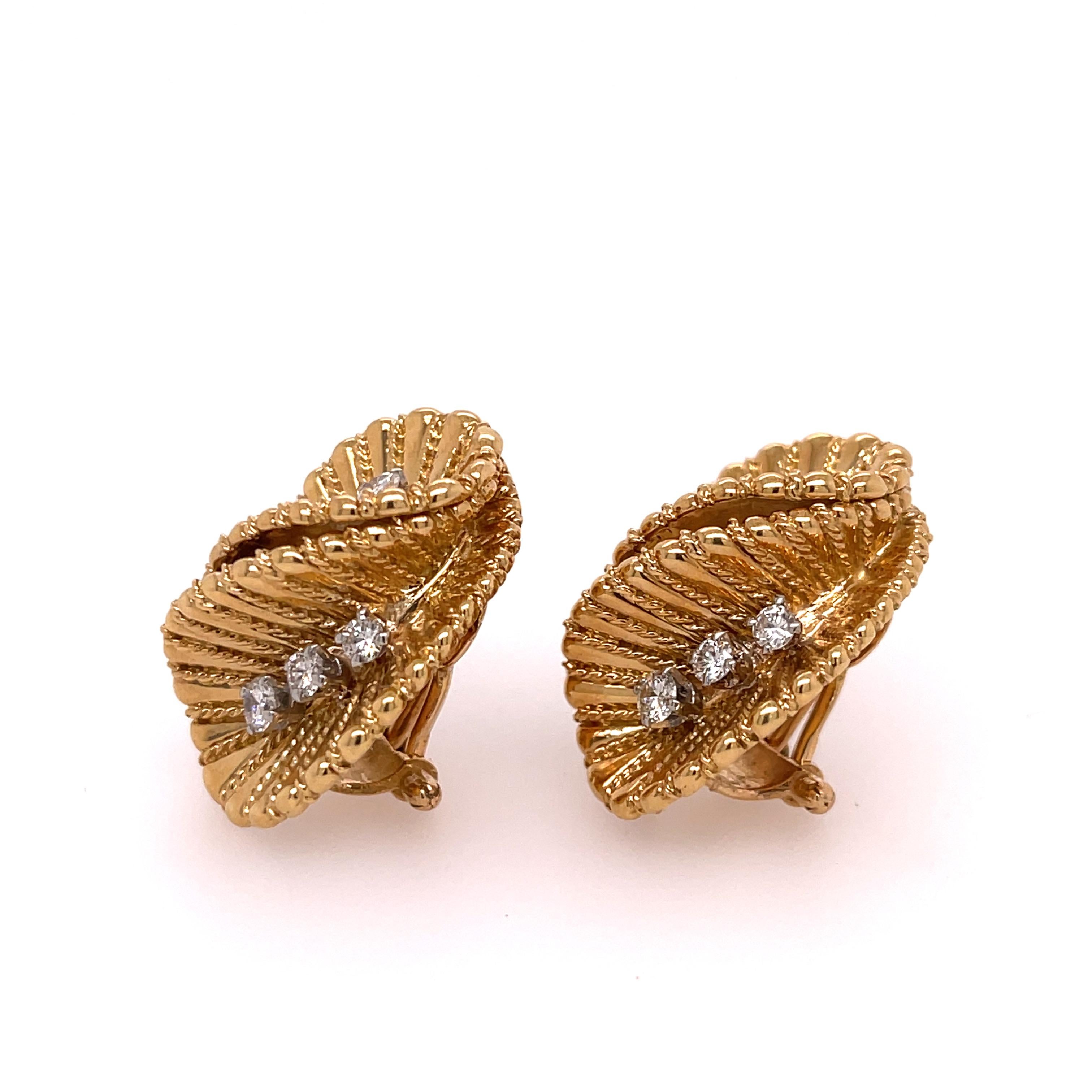 Ruffled leaf clip-on earrings accented with six brilliant cut round diamonds on each earring. The earrings are made in  18K yellow gold.