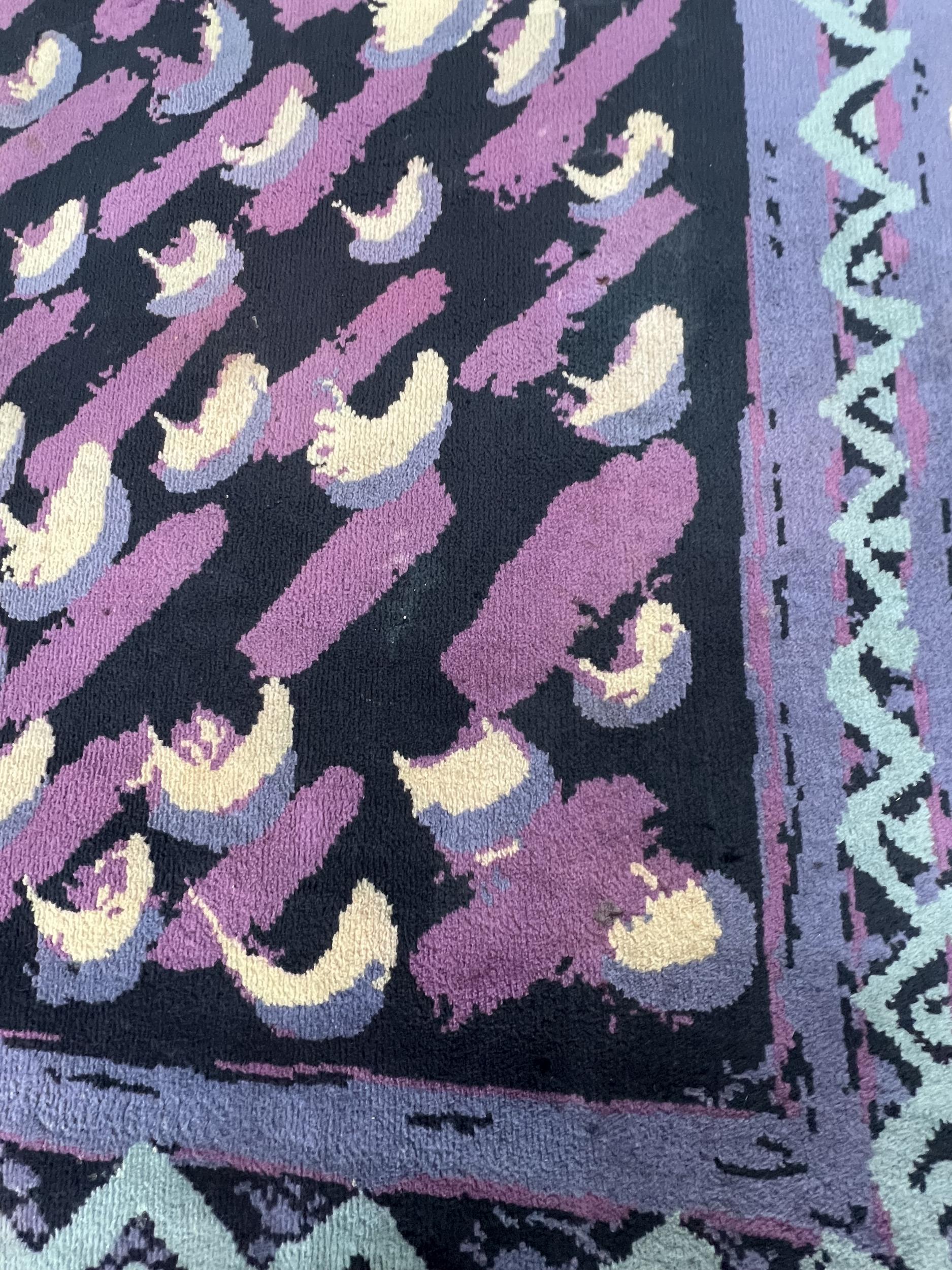 Quality rug (T5), with modernist design in blue, violet and cream on a black background.