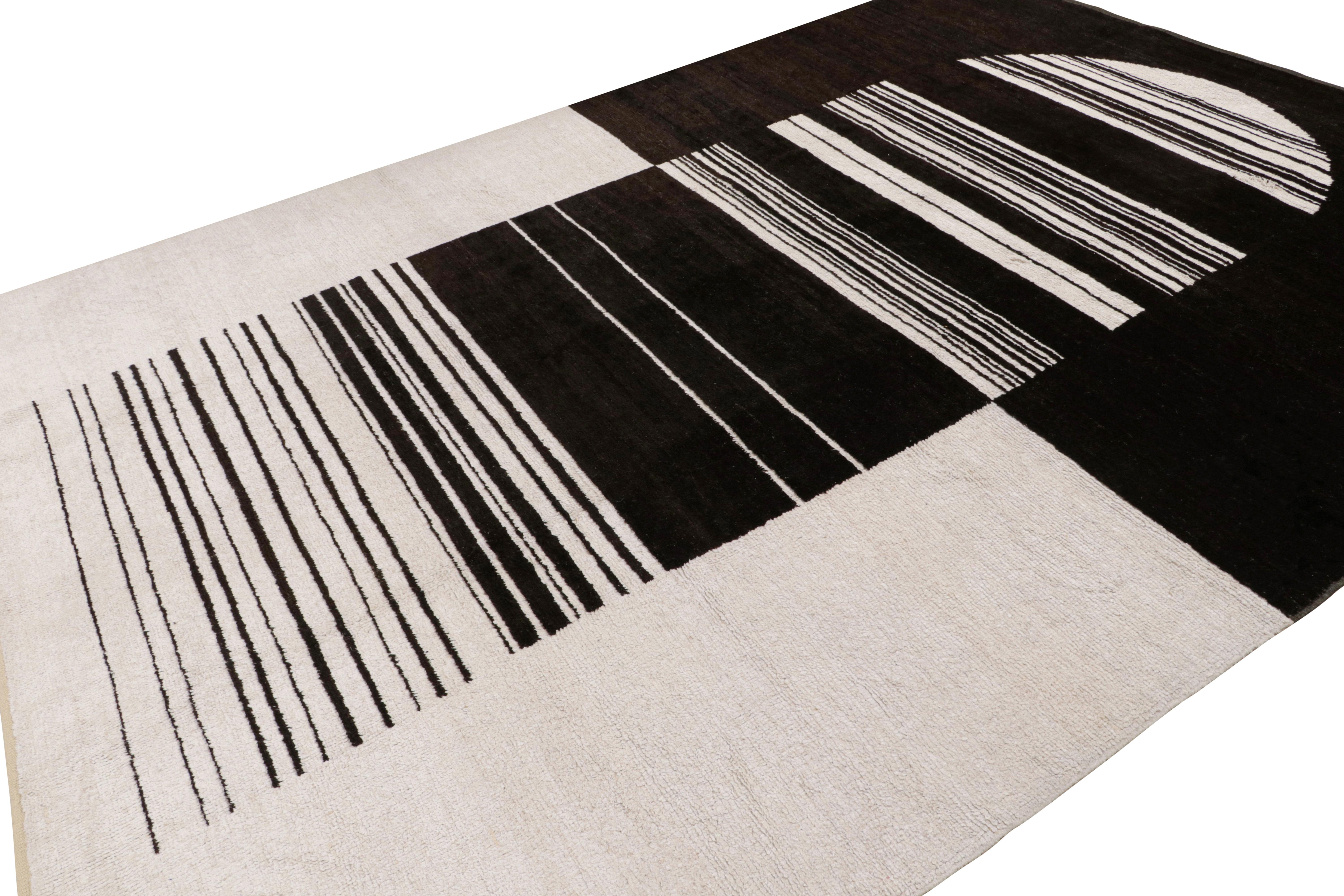 Hand knotted in wool, this 9x13 contemporary rug “Gateway to Heaven” features a design that plays abstract minimalist and Bauhaus moods.

On the Design:

This design features a play of geometric patterns and gradation in white and black tones that