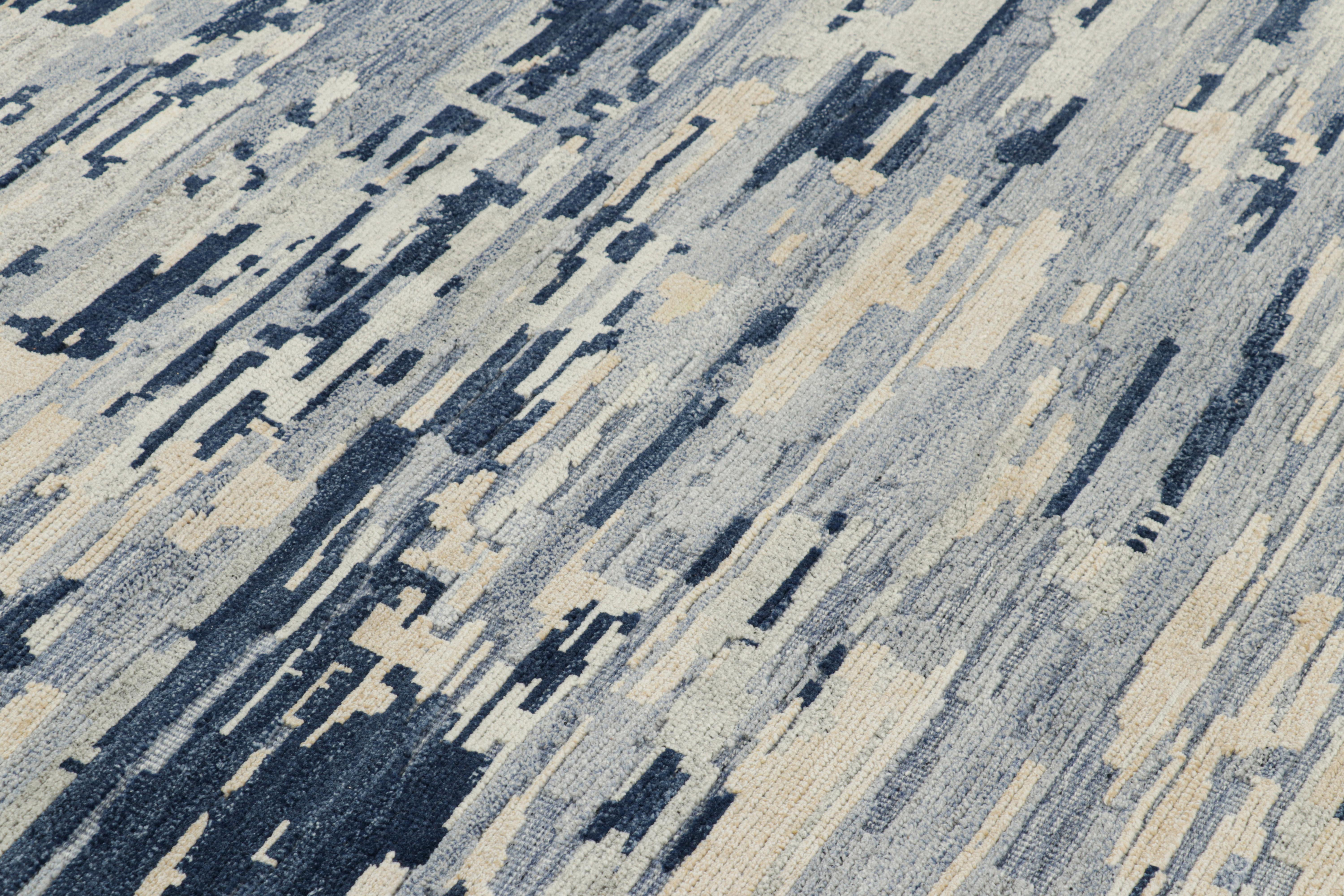Hand-knotted in wool, this 5x6 modern abstract rug features blue and cream white tones underscore geometric patterns like that of painterly brushstrokes, married to a high-low texture. 

On the Design: 

Connoisseurs may admire this piece with