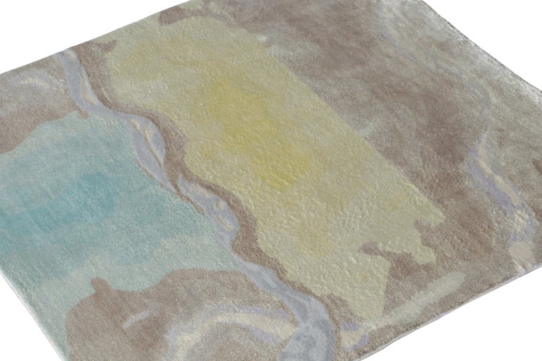 From one of our principal’s finest new partner ateliers, a brilliant square size rug from our contemporary selections. A small-zie favorite from the collection, the rug portrays an abstract attitude in tones of brown, blue & yellow further
