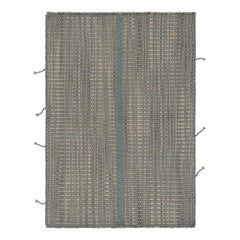 Rug 
Kilim è un kilim d
accento, a strisce grigio-beige con accenti blu.