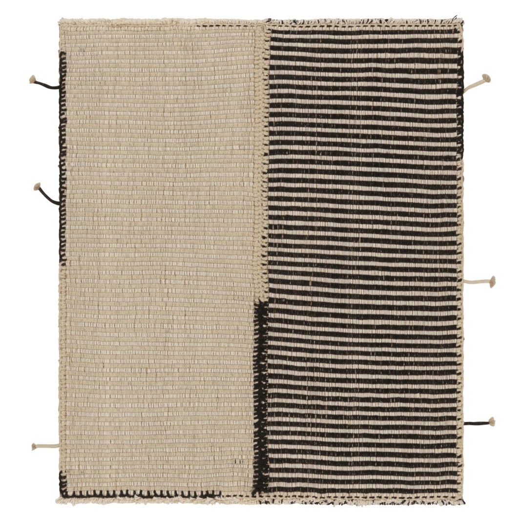 Rug 
Kilim è un tappeto quadrato a strisce bianche e nere, audace e materico.