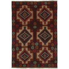 Rug & Kilim’s Afghan Baluch Tribal Rug in Rust Tones with Geometric Medallions