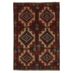 Rug & Kilim’s Afghan Baluch Tribal Rug in Rust Tones with Geometric Medallions