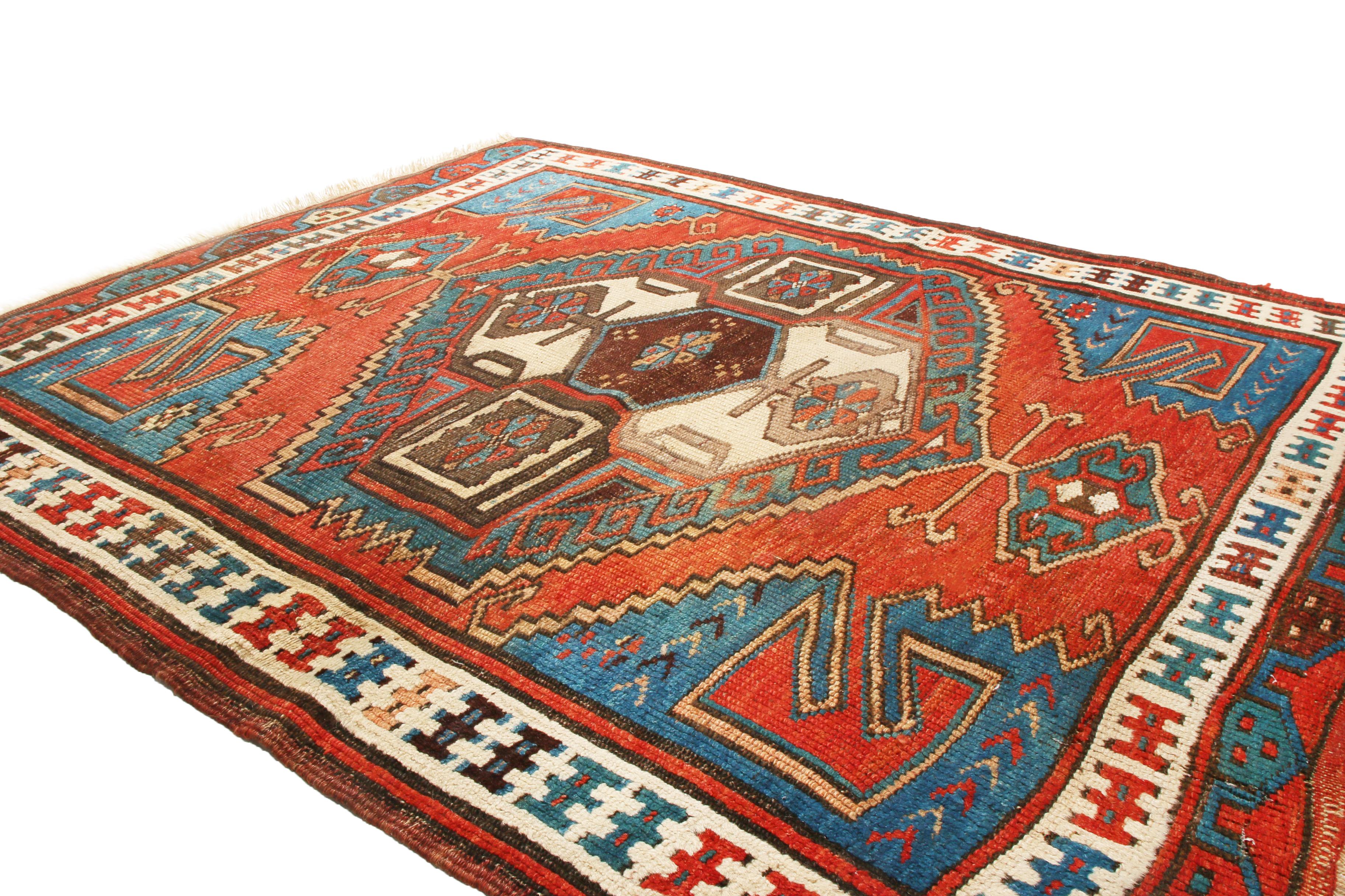 Originating from Turkey between 1900-1920, this antique traditional Turkish rug is of a Bergama design with geometric and floral inspirations. Hand knotted in high-quality wool, these beige, brown, blue, and red geometric gul patterns are