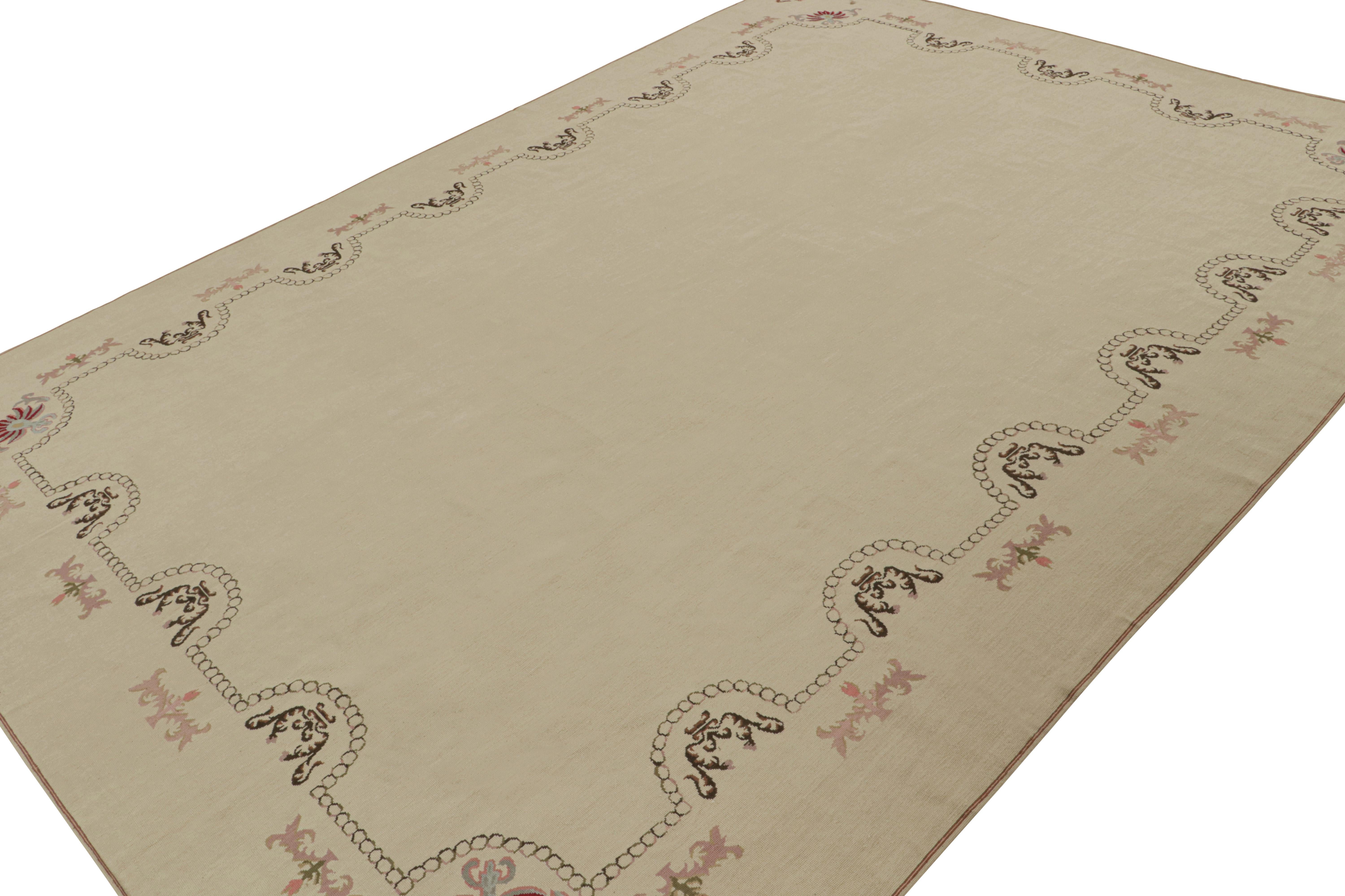 Handwoven in wool, this 9x13 Aubusson flatweave rug draws on a particularly rare design for this aesthetic known for its teeming designs—an open field design in particular, with a minimalist pattern featuring floral garlands and arches. 

On the