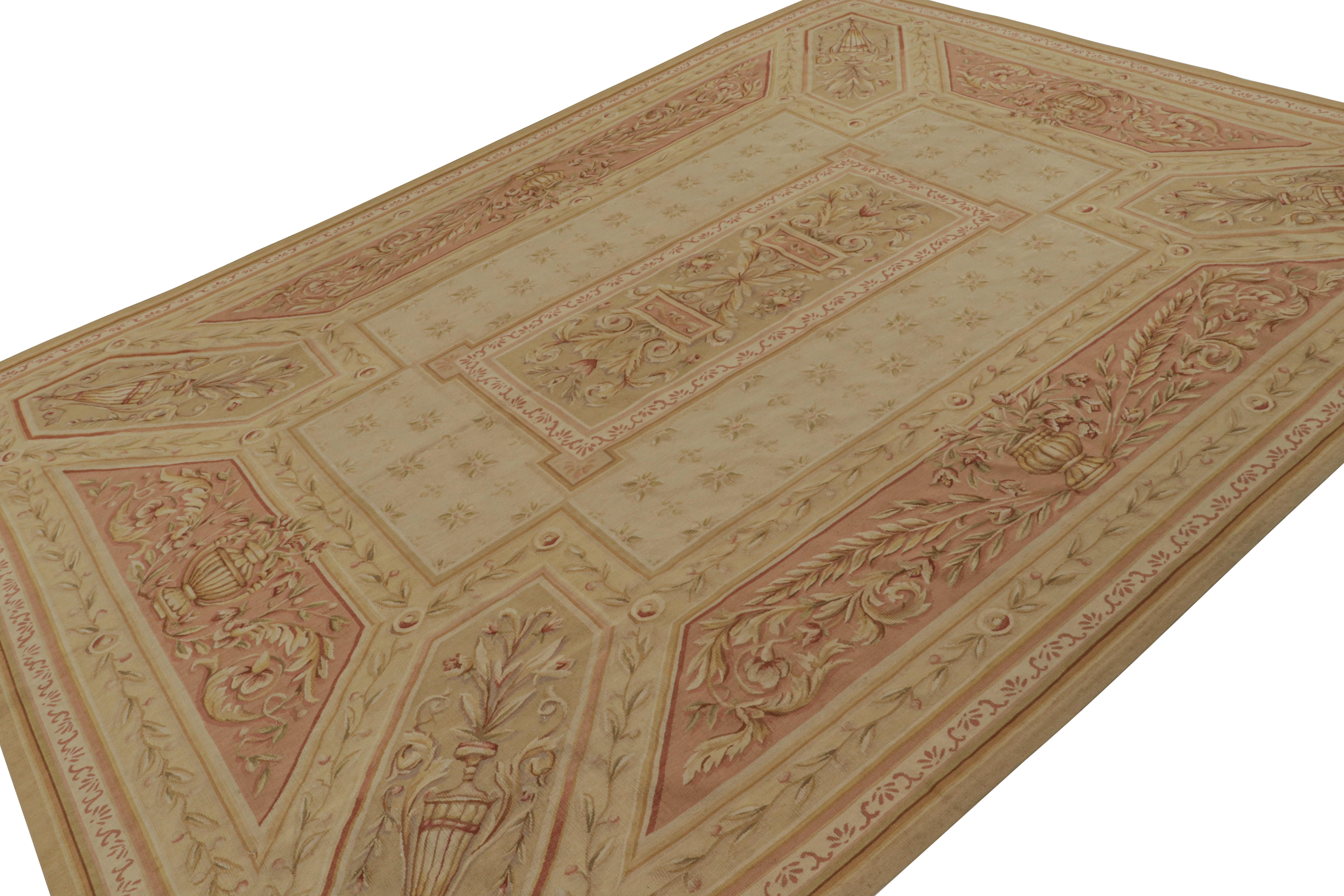 Handwoven in wool, this 8x12 Aubusson flatweave rug from China is quite architectural among those of its kind that inspired this line. The design features a beige/brown field with floral patterns and pictorials in pink, green and gold hues. 

On the