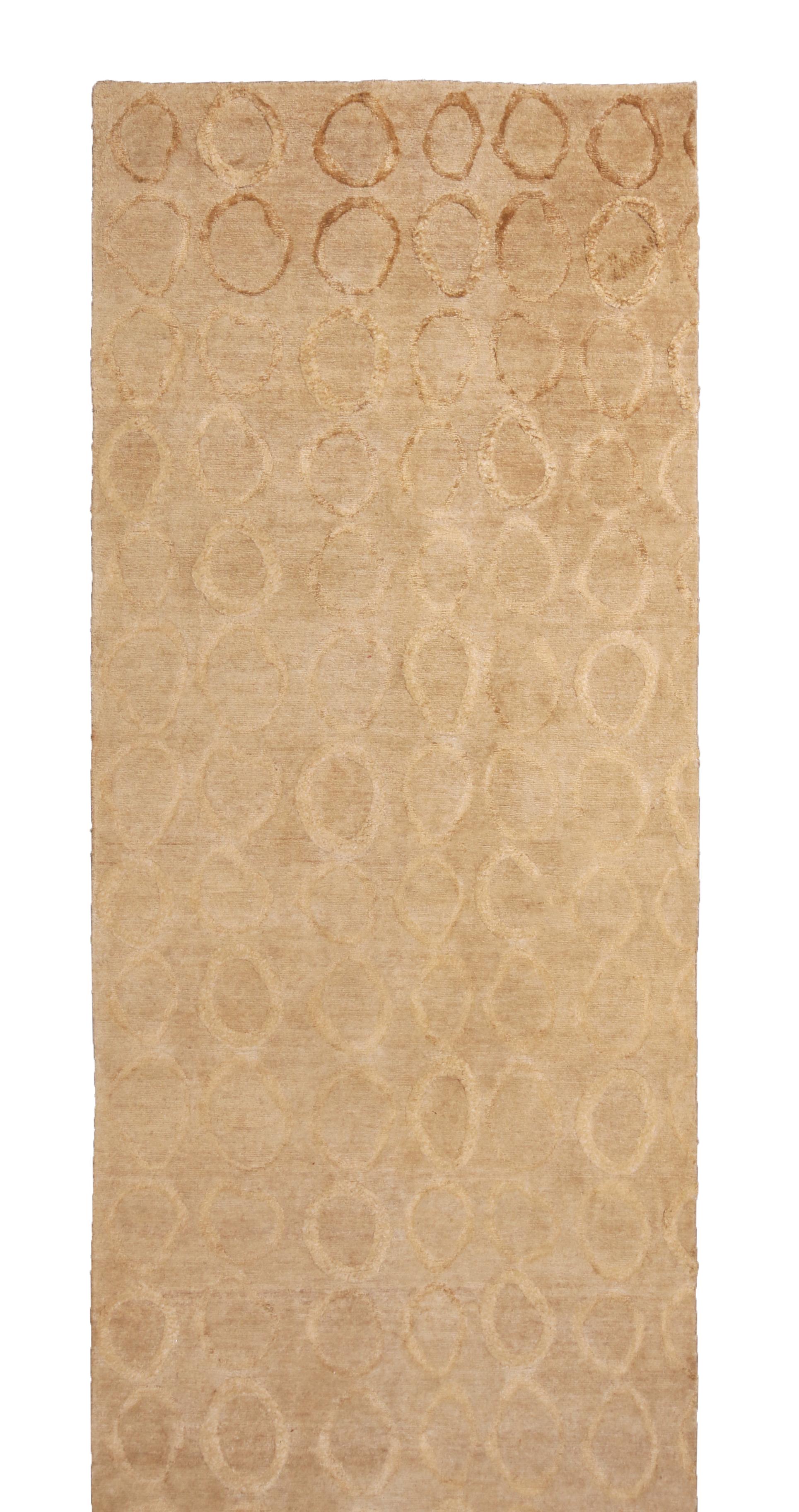 Hand knotted in quality hemp wool and lustrous silk originating from India, this borderless contemporary runner enjoys an inviting, chic balance of beige brown colorways as well as a unique dimensionality in the raised pile geometric circles created