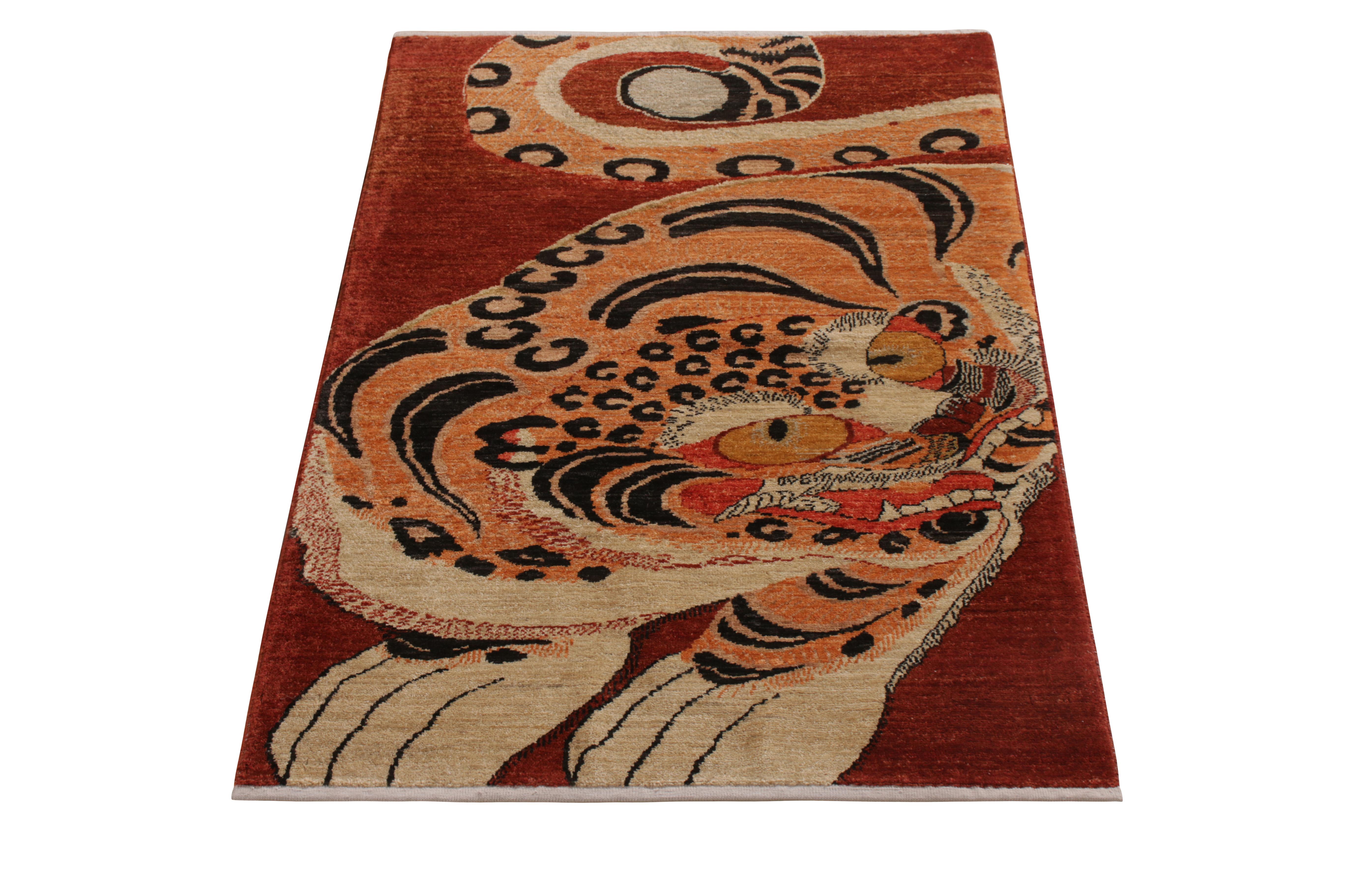 A 3 x 4 ode to celebrated antique Tiger rug styles, from the latest collection by Rug & Kilim. Hand knotted in wool, enjoying warm hues of red and orange playing with a positive-negative black and white in this arresting portrait. Exemplative of the