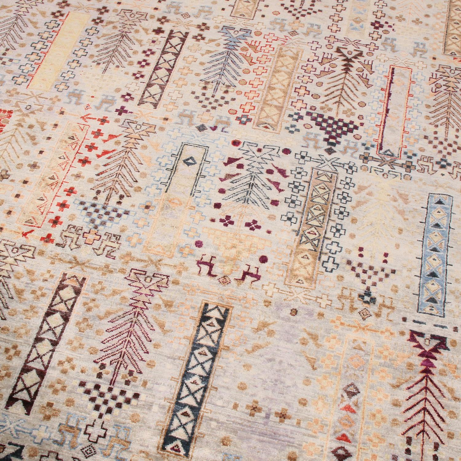 Hand knotted in high-quality wool originating from Afghanistan, this tribal rug hails from Rug & Kilim’s premier Burano collection, enjoying a vivid asymmetrical use of crimson red, blue, and golden-yellow hues complementing the agricultural moods