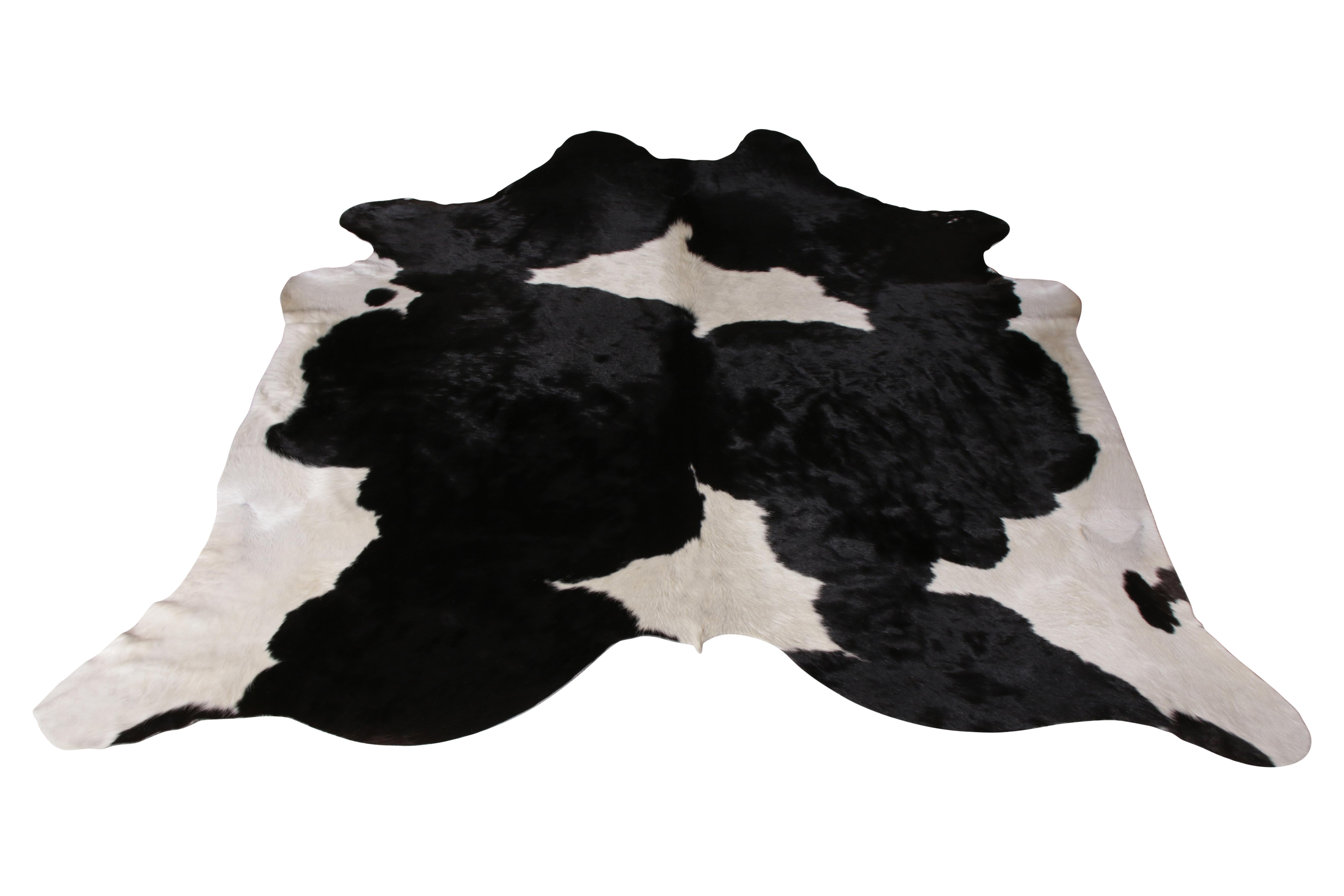 A 7x7 from Rug & Kilim’s line of handmade cowhide rugs. Enjoying a silky, lustrous sheen complementing the positive-negative black and white play with subtle distinction. A comfortable, textural choice, particularly well suited to country homes and