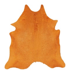 Rug & Kilim’s Contemporary Cowhide Solid Rug in Vibrant Orange Hues