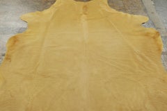 Rug & Kilim’s Contemporary Cowhide Solid Rug in Warm Camel Hues