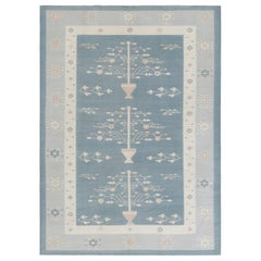 Rug & Kilim’s Contemporary Dhurrie Rug, Ice Blue with White Floral Medallions