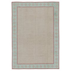 Rug & Kilim’s Contemporary Dhurrie Rug in Beige with Teal and Rose Border