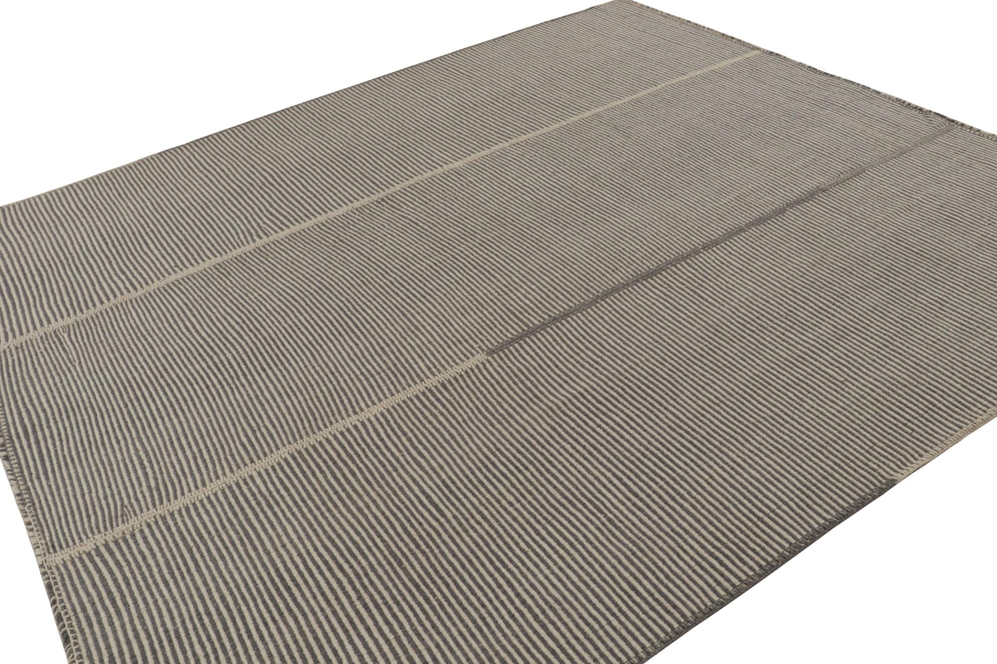 Handwoven in wool, a 9x10 Kilim in beige and gray tones, from a bold new line of contemporary flatweaves, ‘Rez Kilim’, by Rug & Kilim.

On the design: 

Connoting a modern take on classic panel-weaving, our latest “Rez Kilim” enjoys beige, brown and